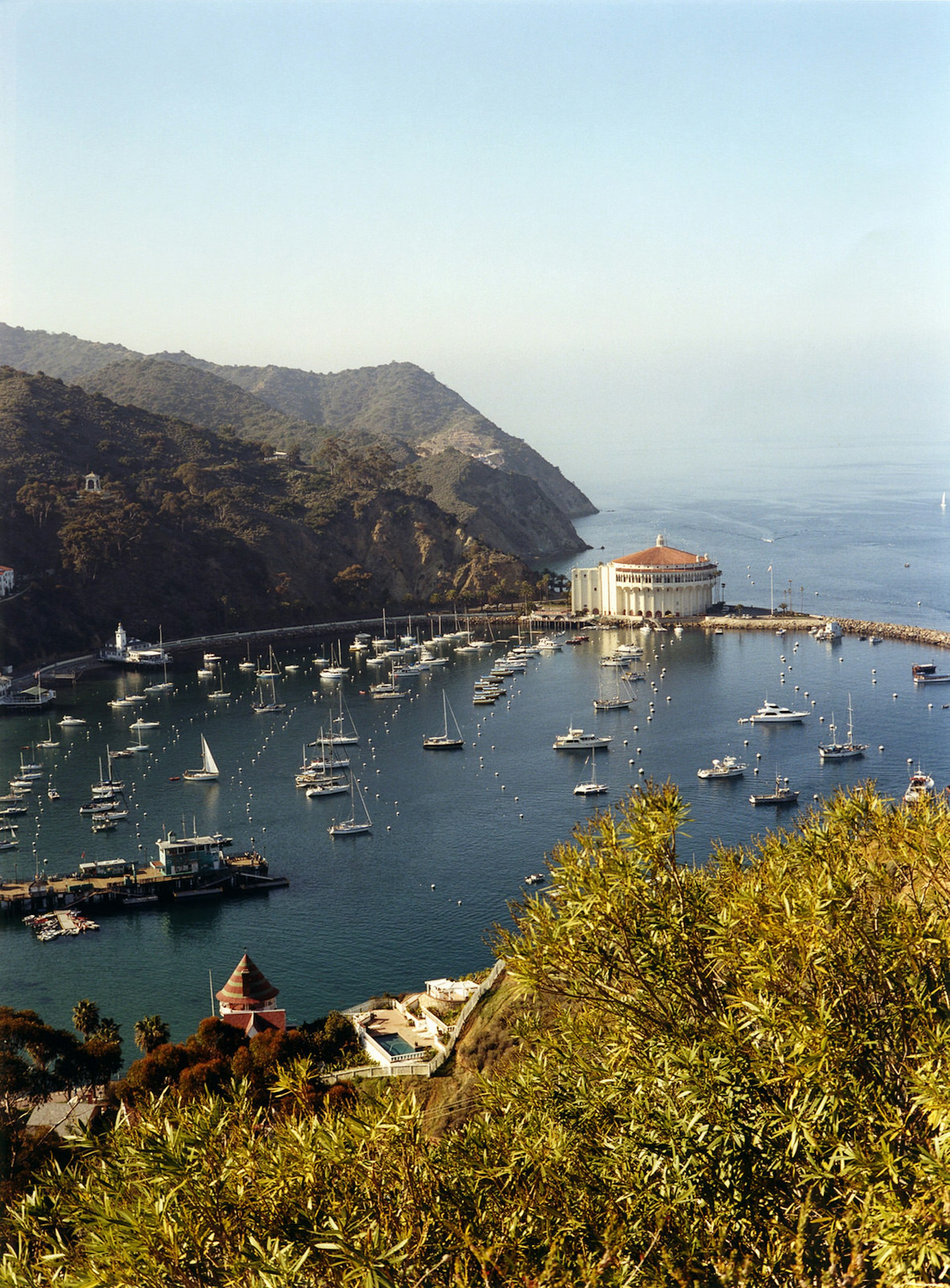A view from high above the crescent-shaped Avalon Harbor on Catalina Island, in California, and looking out to the sea.
