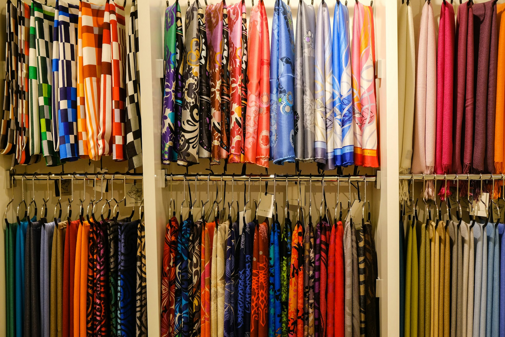Neat display of silk scarves hanging up in the Marja Kurki store, Helsinki © Tim Bird / Lonely Planet