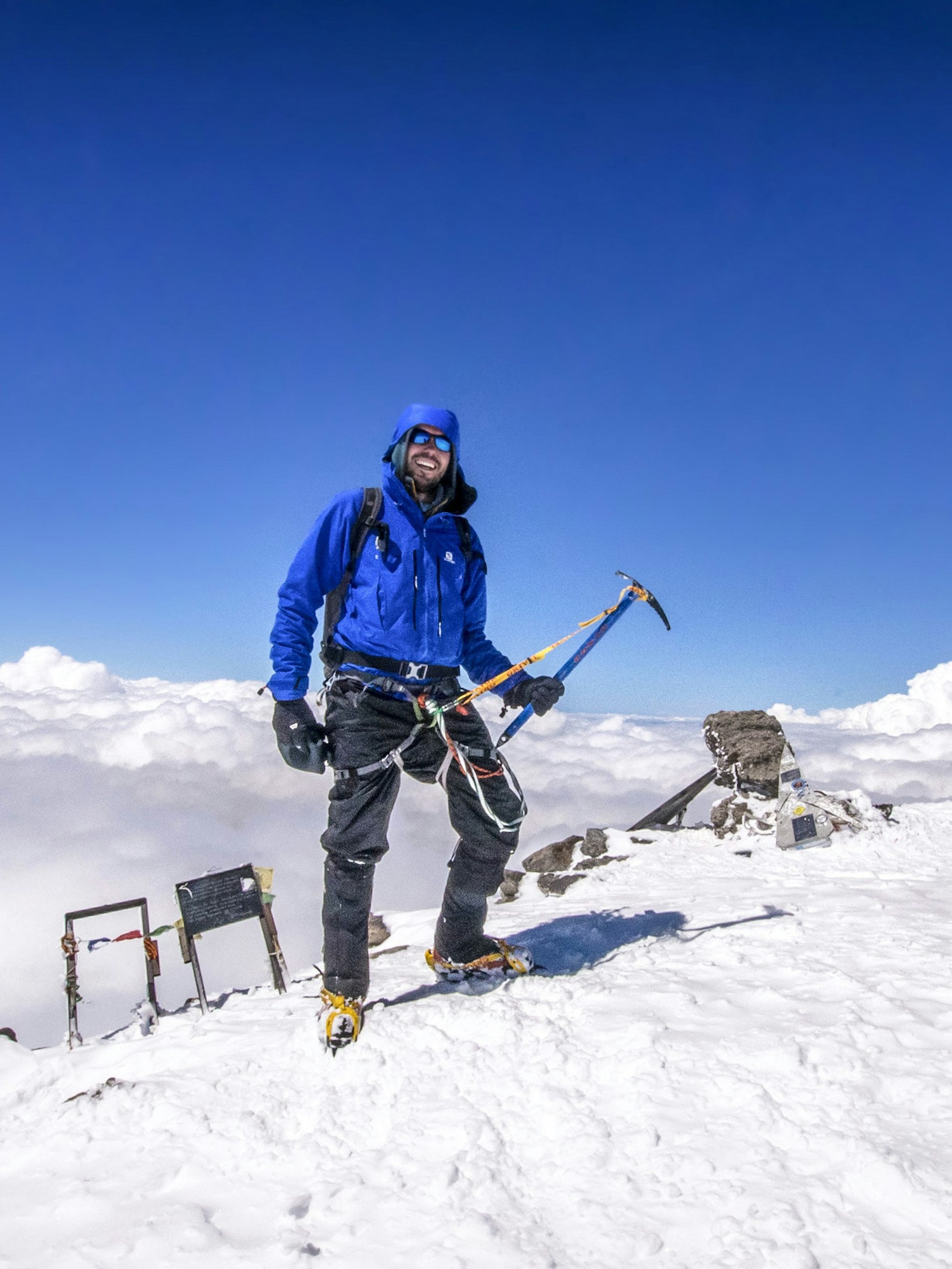 The writer stands triumphantly atop Mt Elbrus (5642m), Europe’s highest mountain © Peter Watson / Lonely Planet