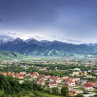 View of Almaty with red-roofed houses and snow-capped mountains in the distance The mountains and deserts of Kazakhstan's southern wilderness is right on Almaty's doorstep © Aureliy / Shutterstock