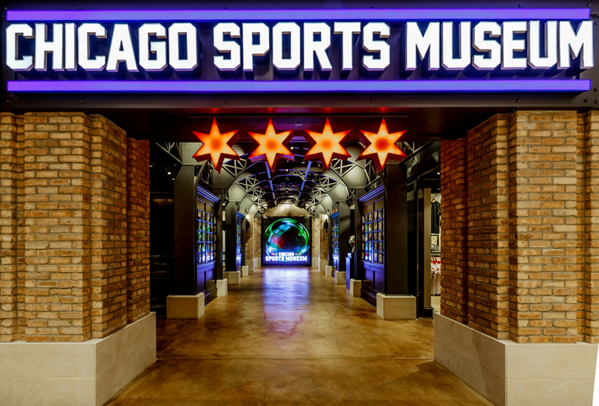 brick pilllars and a bold blue sign mark the entrance of Chicago Sports Museum