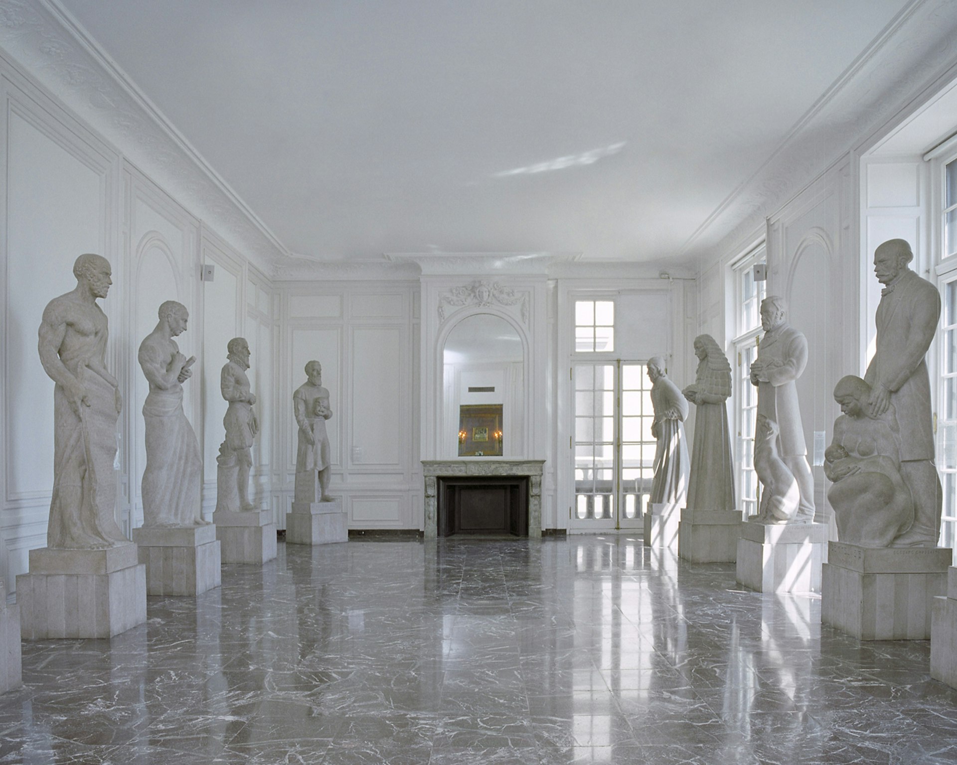 white marble statues of famous medical figures line a room in the Museum of Surgical Science