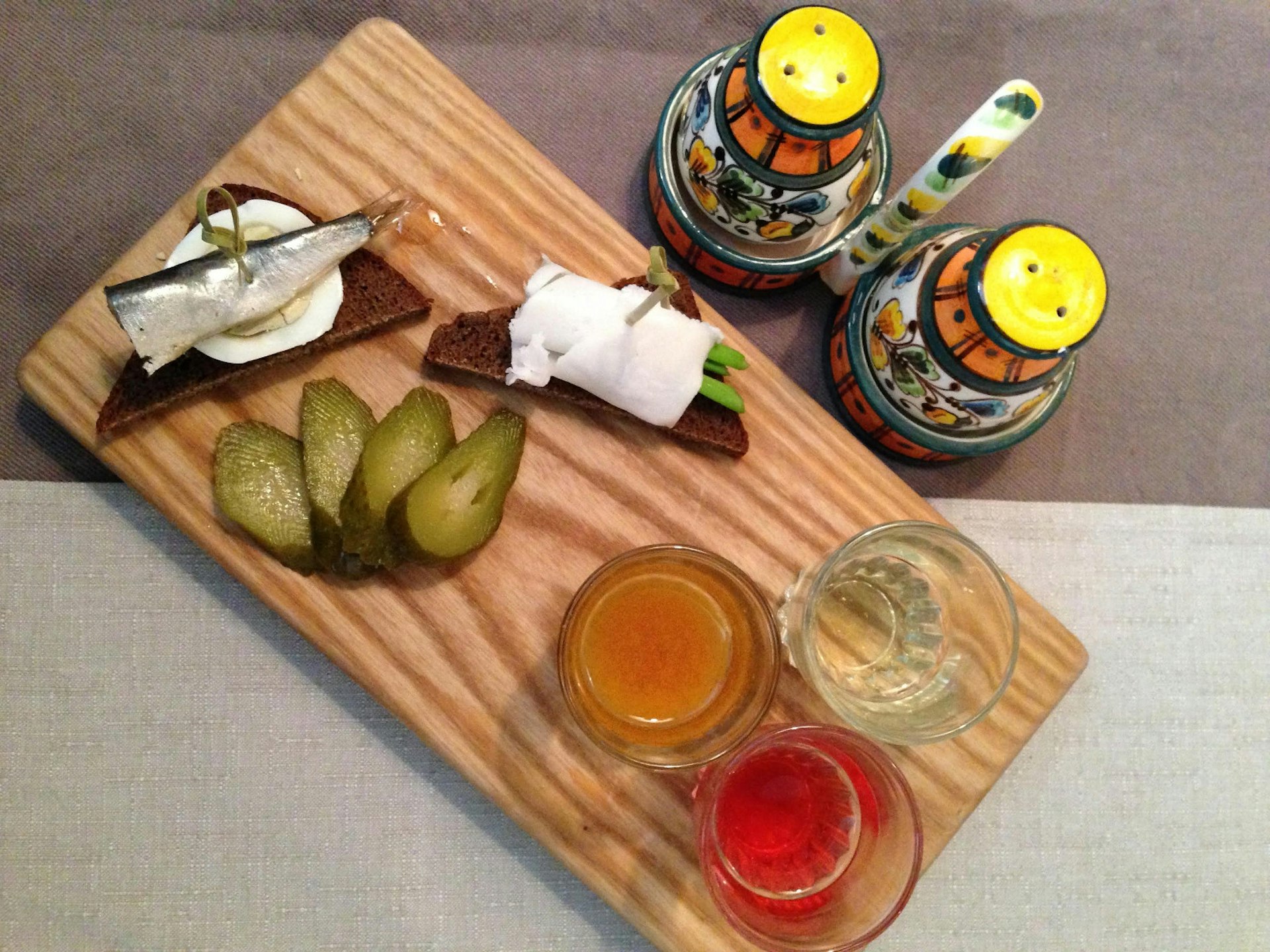 Flavoured vodka with <em>zakuski (appetisers) – it's traditional to nibble on something after each shot © Simon Richmond / Lonely Planet