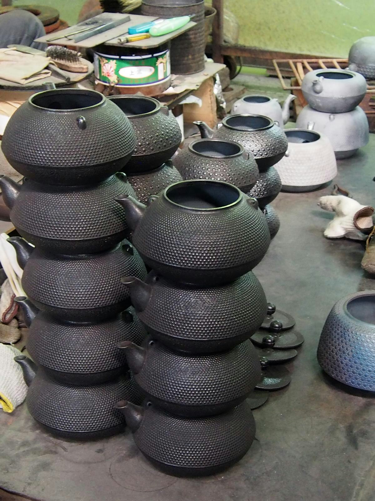 Stacks of cast-iron pots in the Iwachu workshop © Manami Okazaki / Lonely Planet