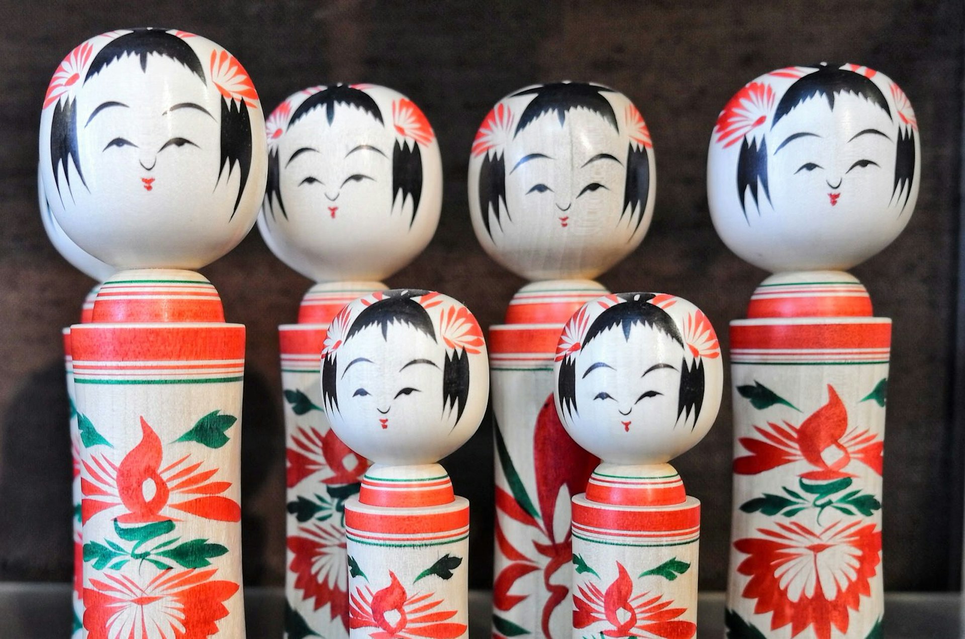 A collection of finished kokeshi with painted faces and chrysanthemum motifs on the body © Manami Okazaki / Lonely Planet