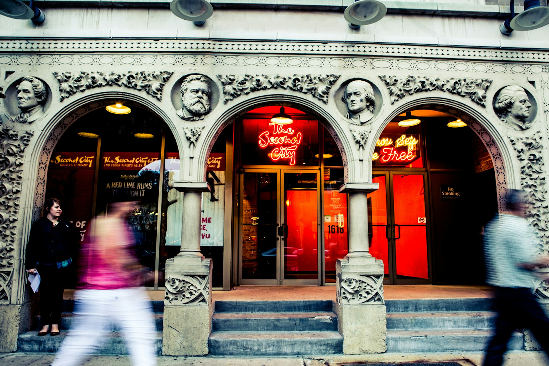 person walks in front of Chicago's Second City Improv theater's neoclassical facade