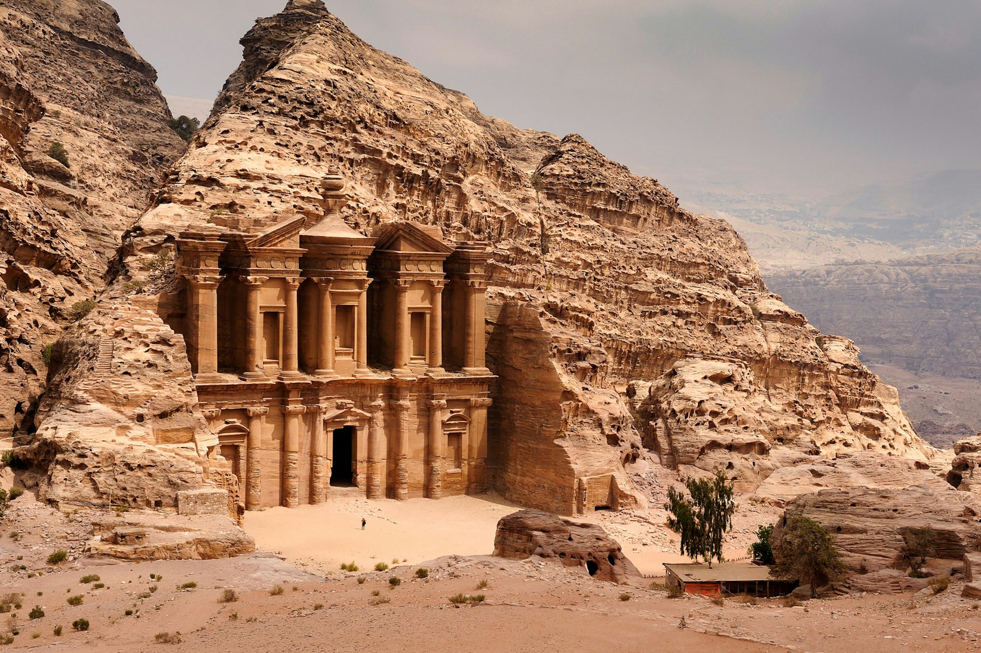 A classic view of El Deir, The Monastery in Petra. Shown in the context of the mountain that the facade was carved out of by the Nabataeans in the 1st century. The facade measures 50 metres wide by approximately 45 meters high. Image by Nick Brundle Photography / Getty Images