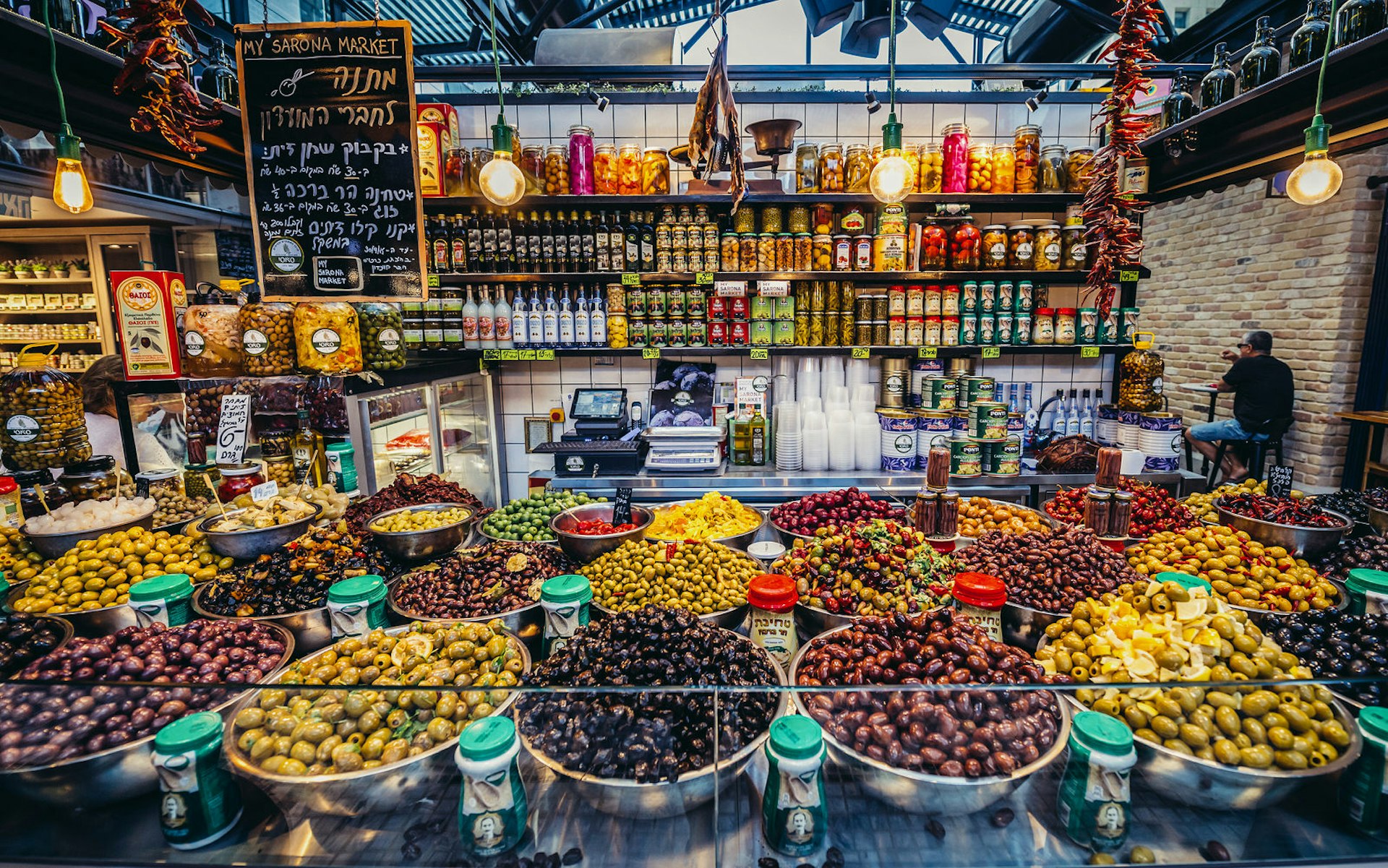 Olives for sale at the popular Sarona Market, a covered public market in Tel Aviv. Image by Fotokon / Shutterstock
