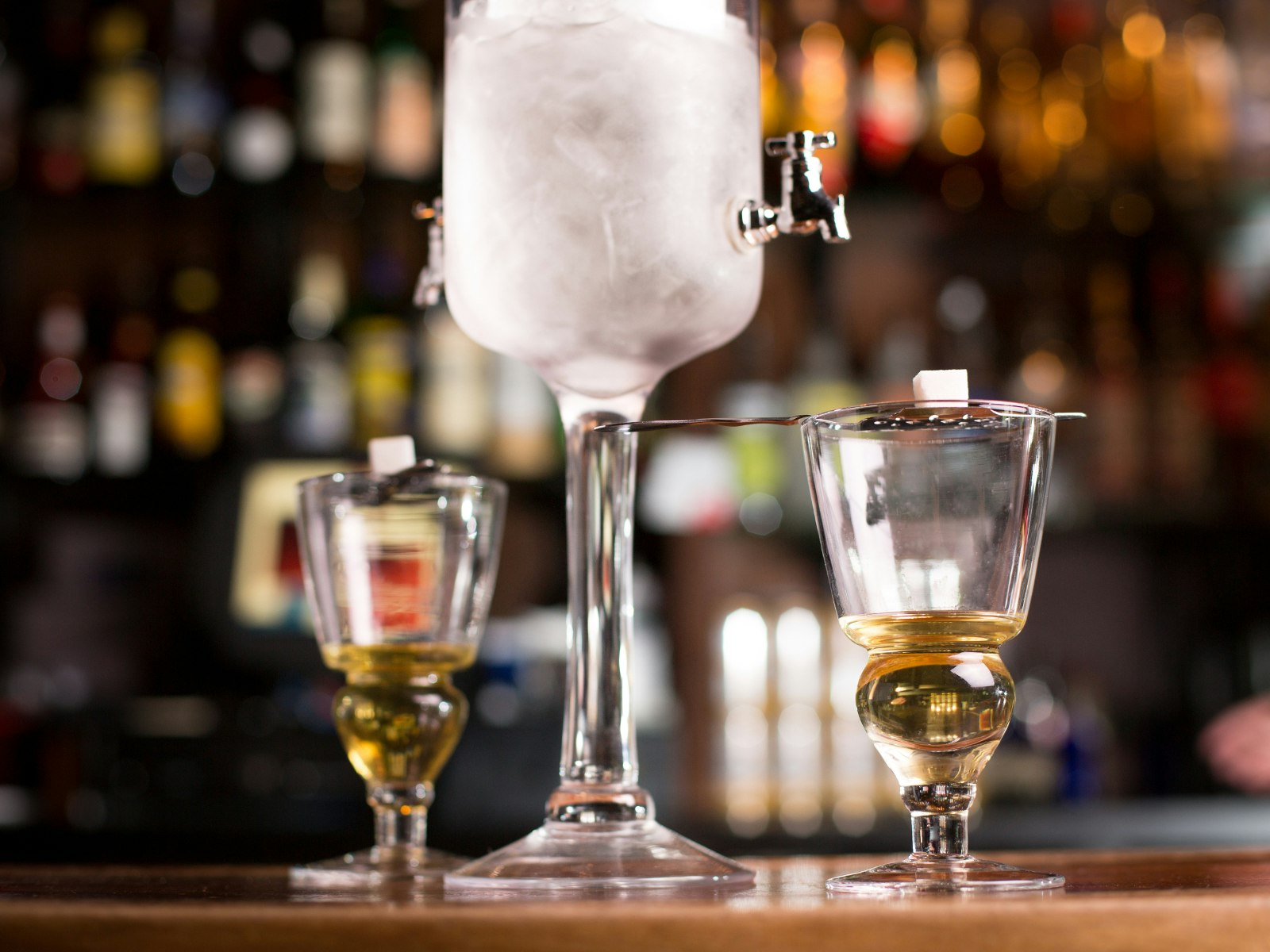 An old-fashion absinthe fountain with two shots of absinthe 