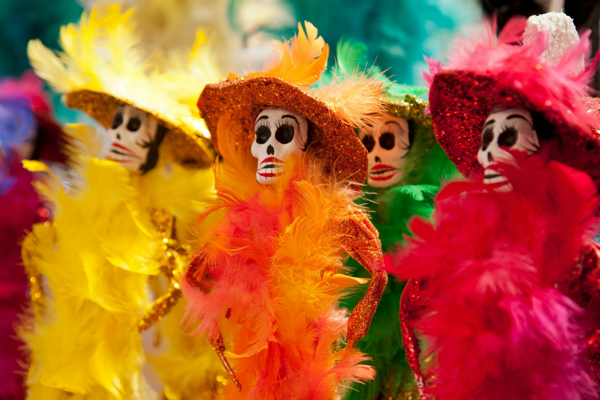 Skeleton dolls in colorful outfits mark the Day of the Dead