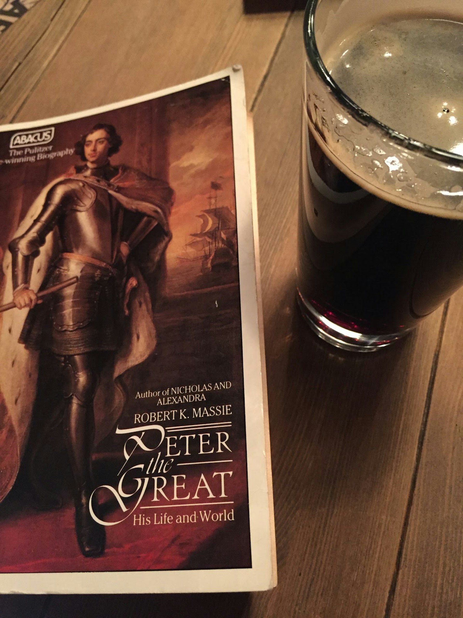 A book of Robert K Massie's Peter the Great on a table next to a pint of dark beer © Megan Eaves / Lonely Planet 