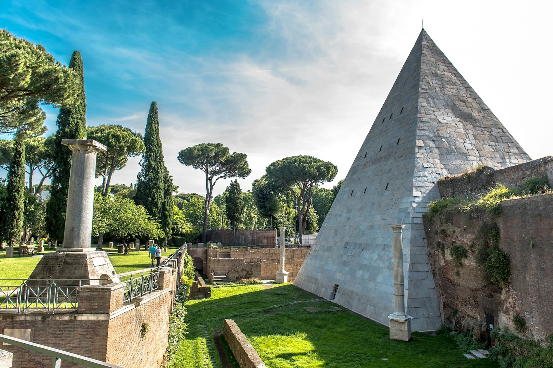 Visitors explore Testaccio neighbourhood's Non-Catholic Cemetery, in the shadow of the Pyramid of Cestius
