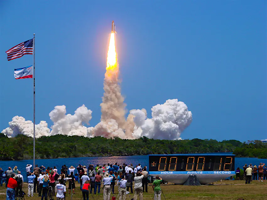 Features - Spectators watch as the final NASA shuttle, Atlantis, takes off at Cape Canaveral © crowd watches as the countdown clock hits zero and the space shuttle Atlantis launches into orbit in 2011; how to experience a rocket launch on Florida's Space Coast