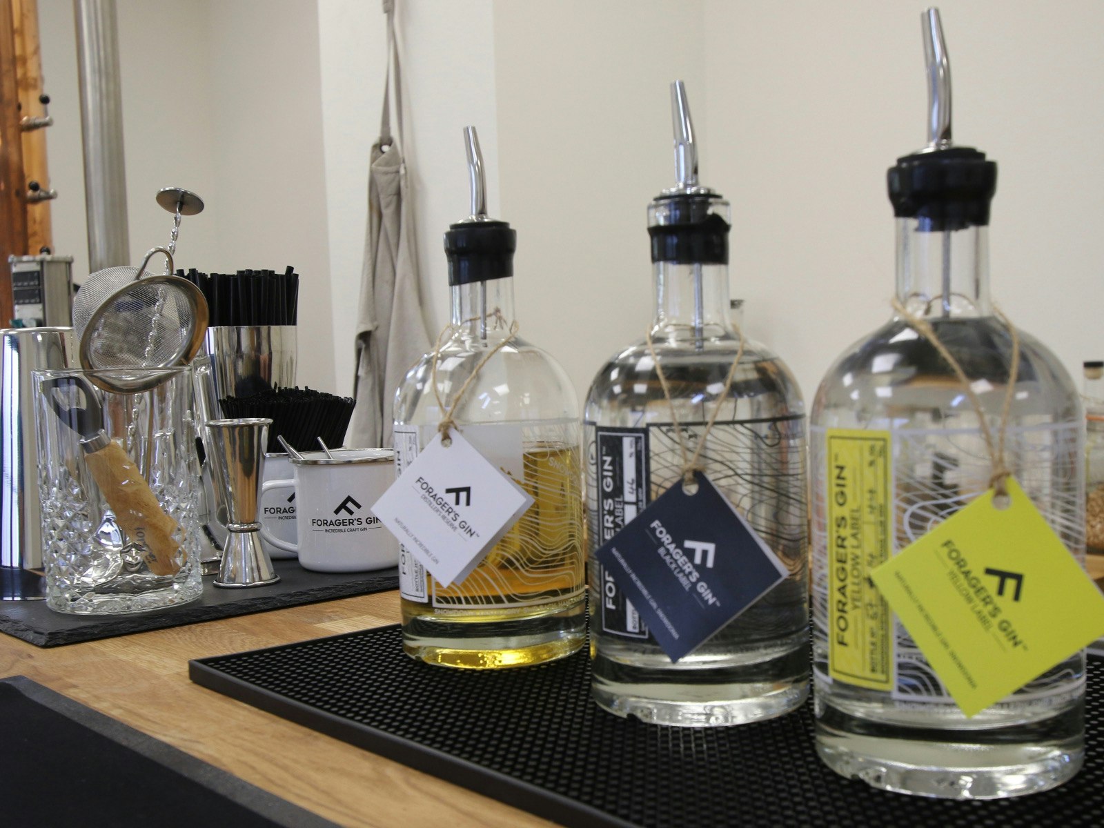 Three bottles of gin on a work surface at the Snowdonia Distillery 