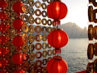 Red Chinese New Year lanterns and gold-coin decorations along Victoria Harbour © Gabrielle Chan / Shutterstock
