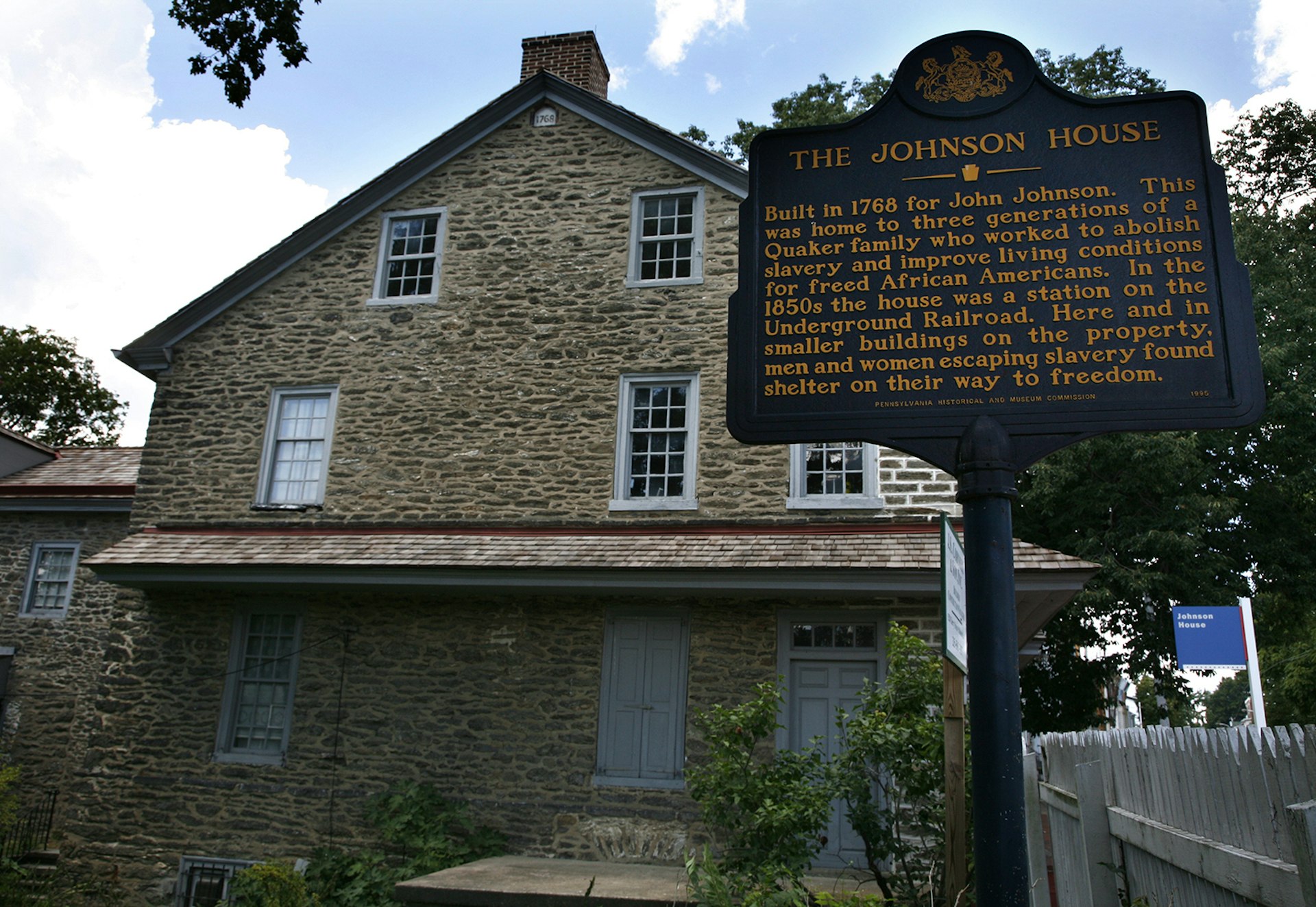 An 18th -century stone home in Philadelphia with a historic marker sign in front of it