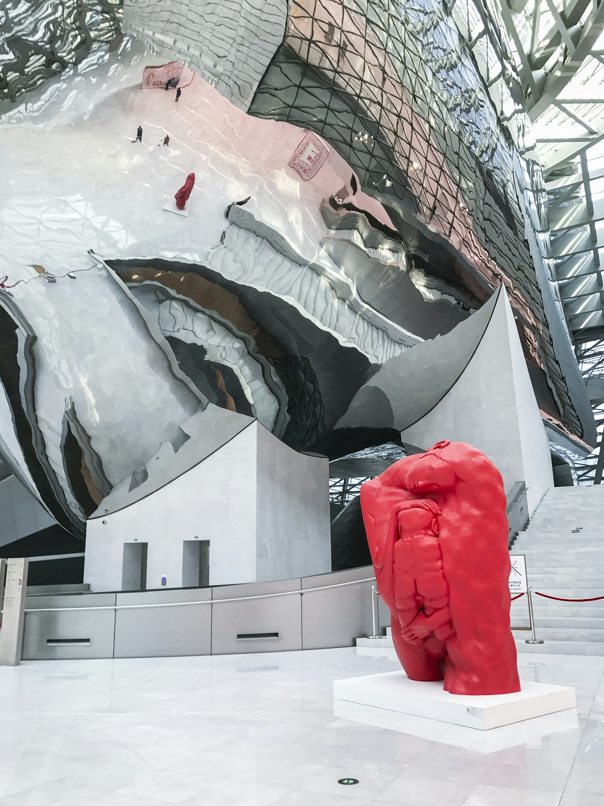 A shiny bubble installation provides a mirror effect next to a red contemporary art sculpture. Snapping a reflective-bubble selfie inside the Museum of Urban Art and Contemporary Planning © Cathy Adams / Lonely Planet
