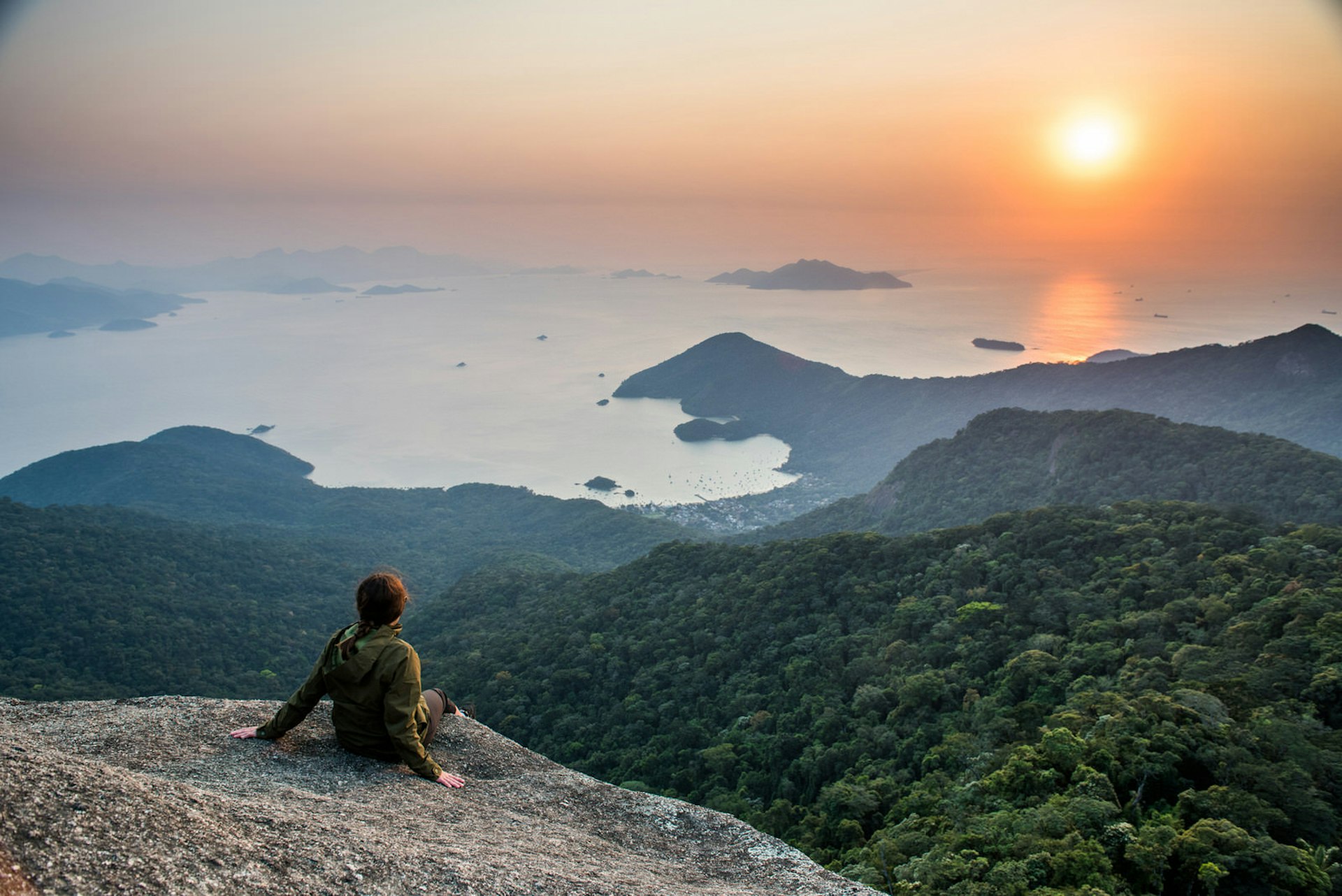 Hiker savouring a panoramic view of Ilha Grande, Brazil © vitormarigo / Shutterstock 