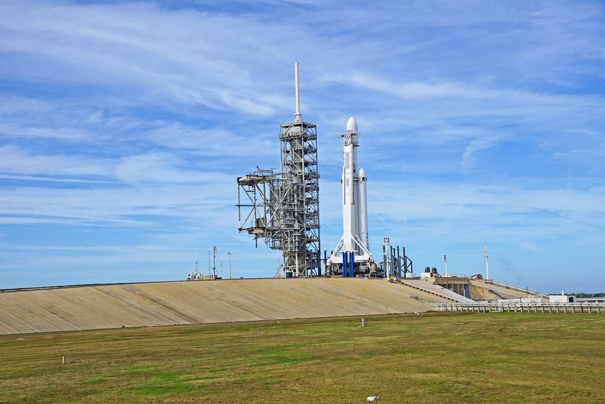 spacex shuttle on the launchpad in Florida, with sunny blue skies