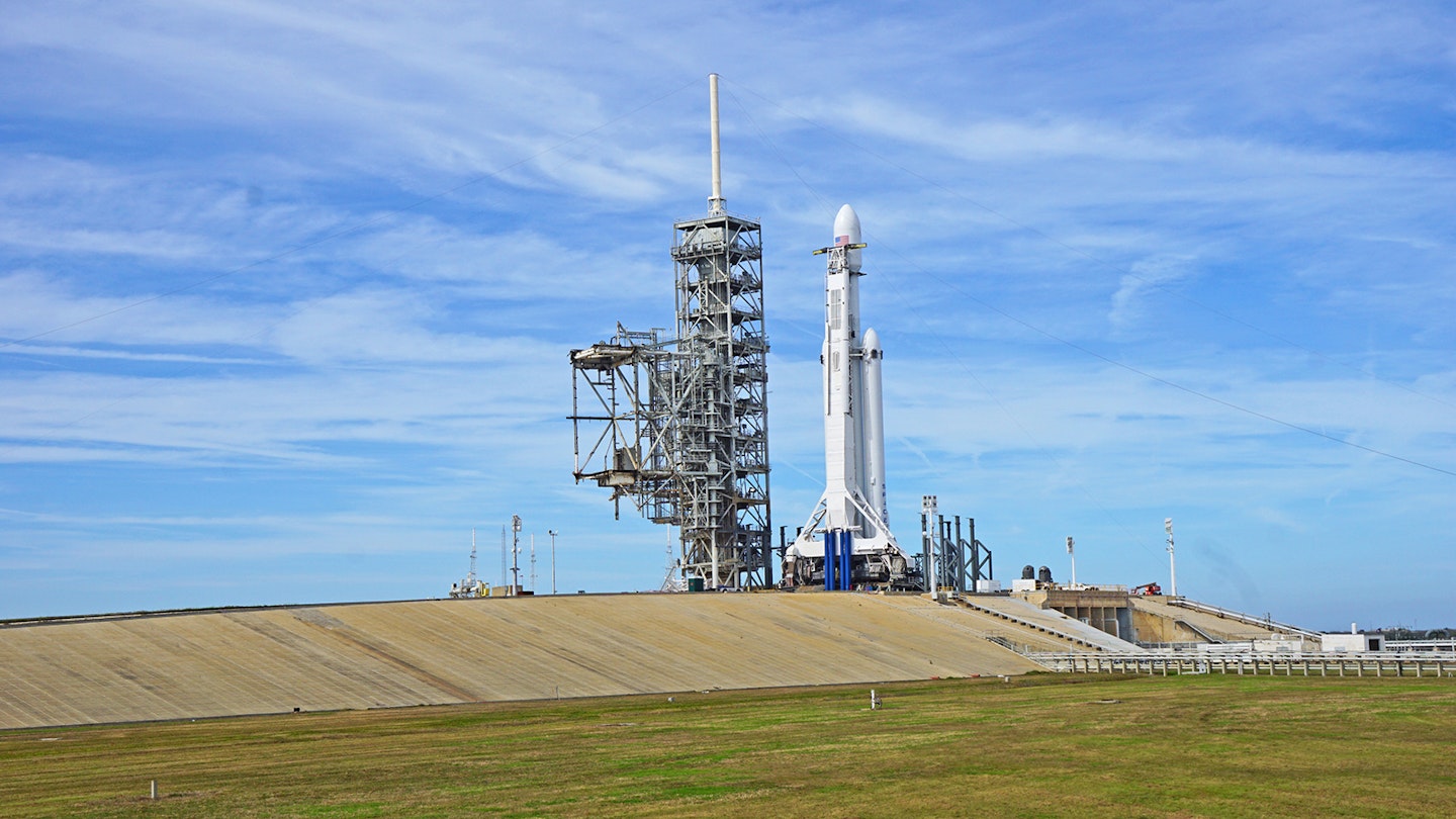 spacex shuttle on the launchpad in Florida, with sunny blue skies