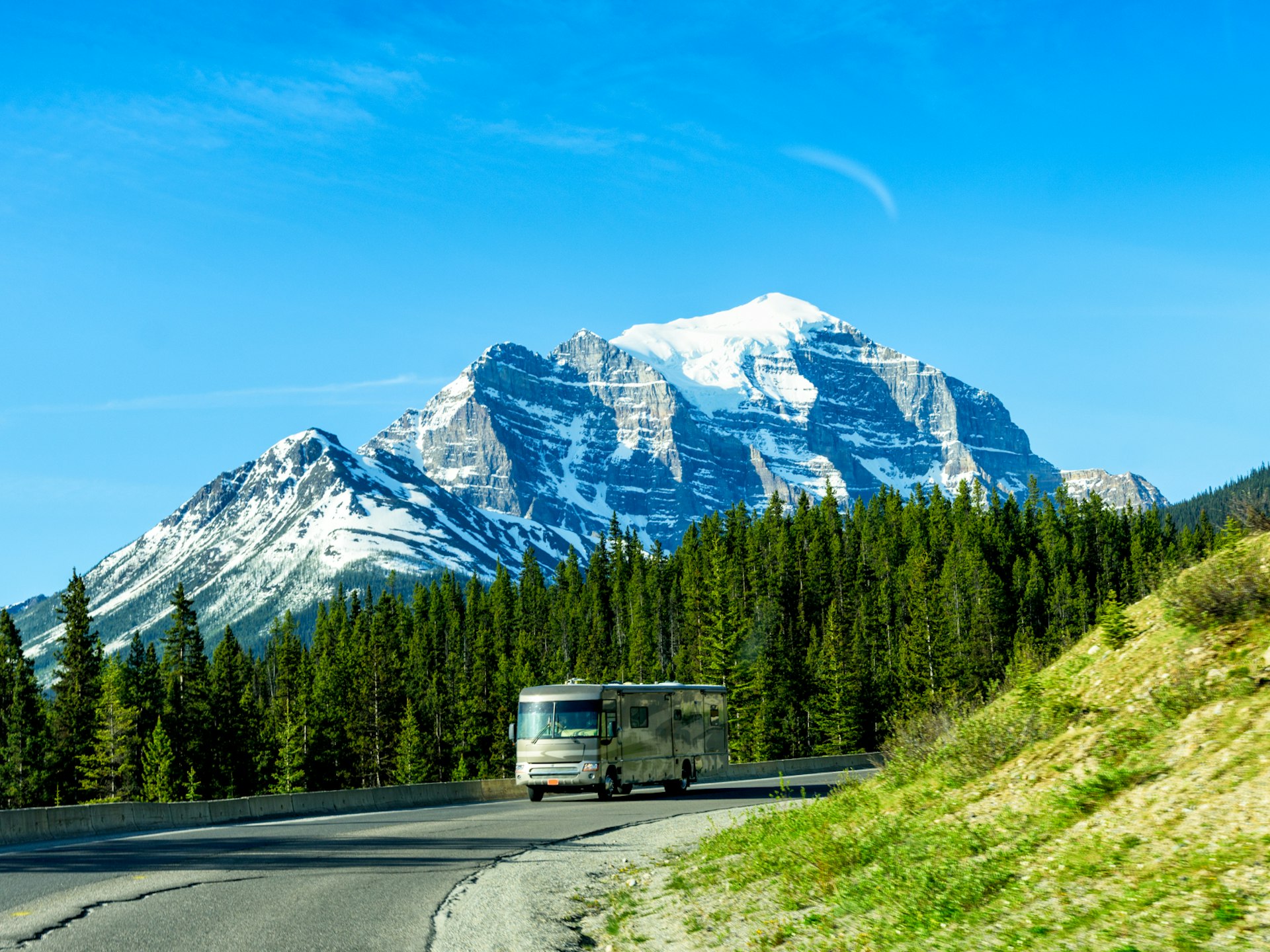 A campervan driving through Banff National Park