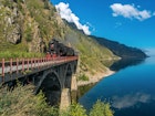 Steam train chugging across a bridge on the Circum-Baikal Railway @ Tilpunov Mikhail / Shutterstock