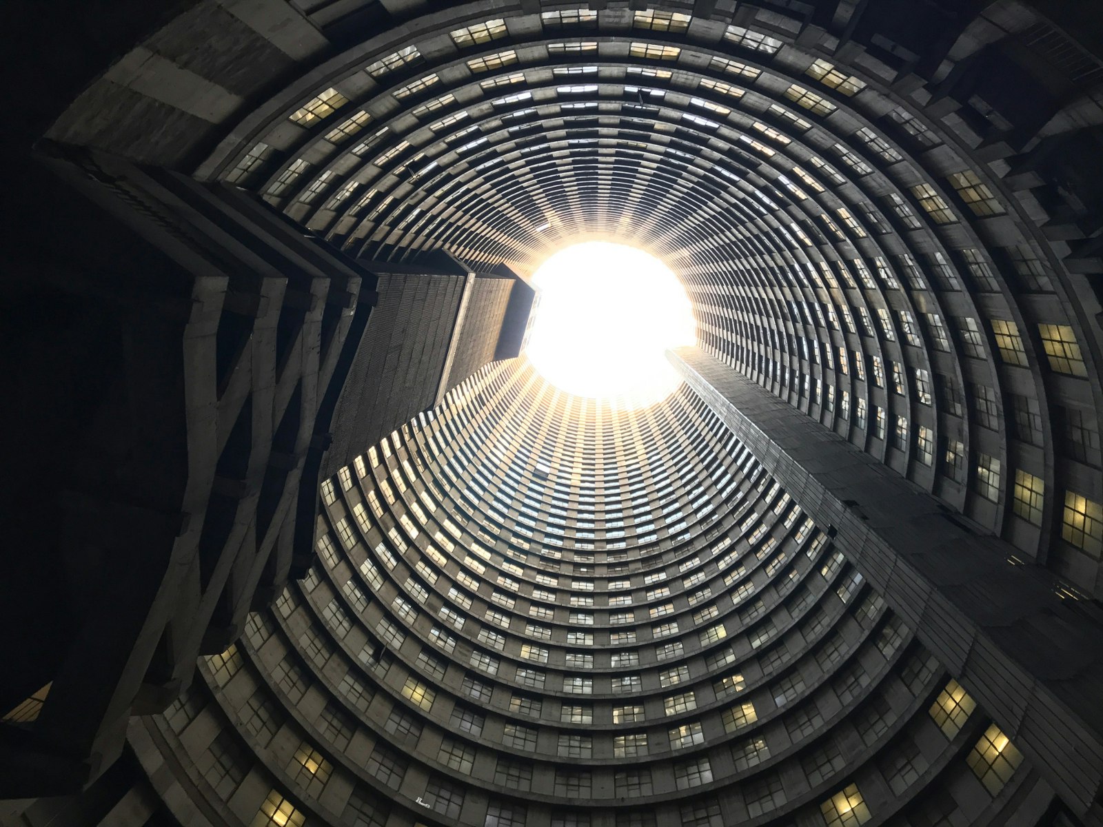 The picture is taken from inside the base of the 54-storey Ponte City tower, with the view looking up its cylindrical core to the circular hole at the top. The sky glows like a sun. © Simon Richmond / Lonely Planet