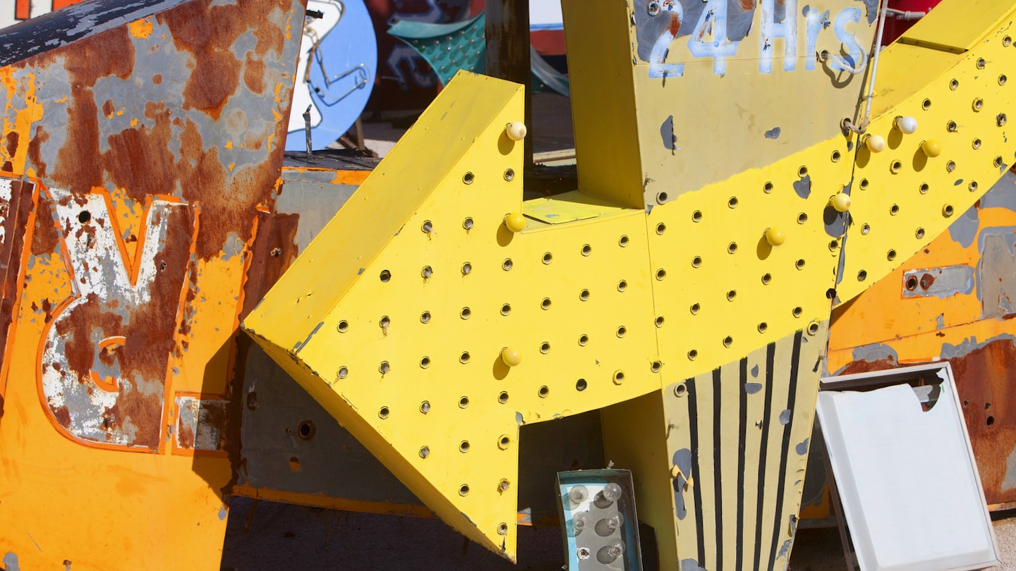 Close up view of dusty, old Las Vegas neon signs in a state of disrepair in a junkyard