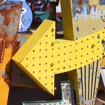 Close up view of dusty, old Las Vegas neon signs in a state of disrepair in a junkyard