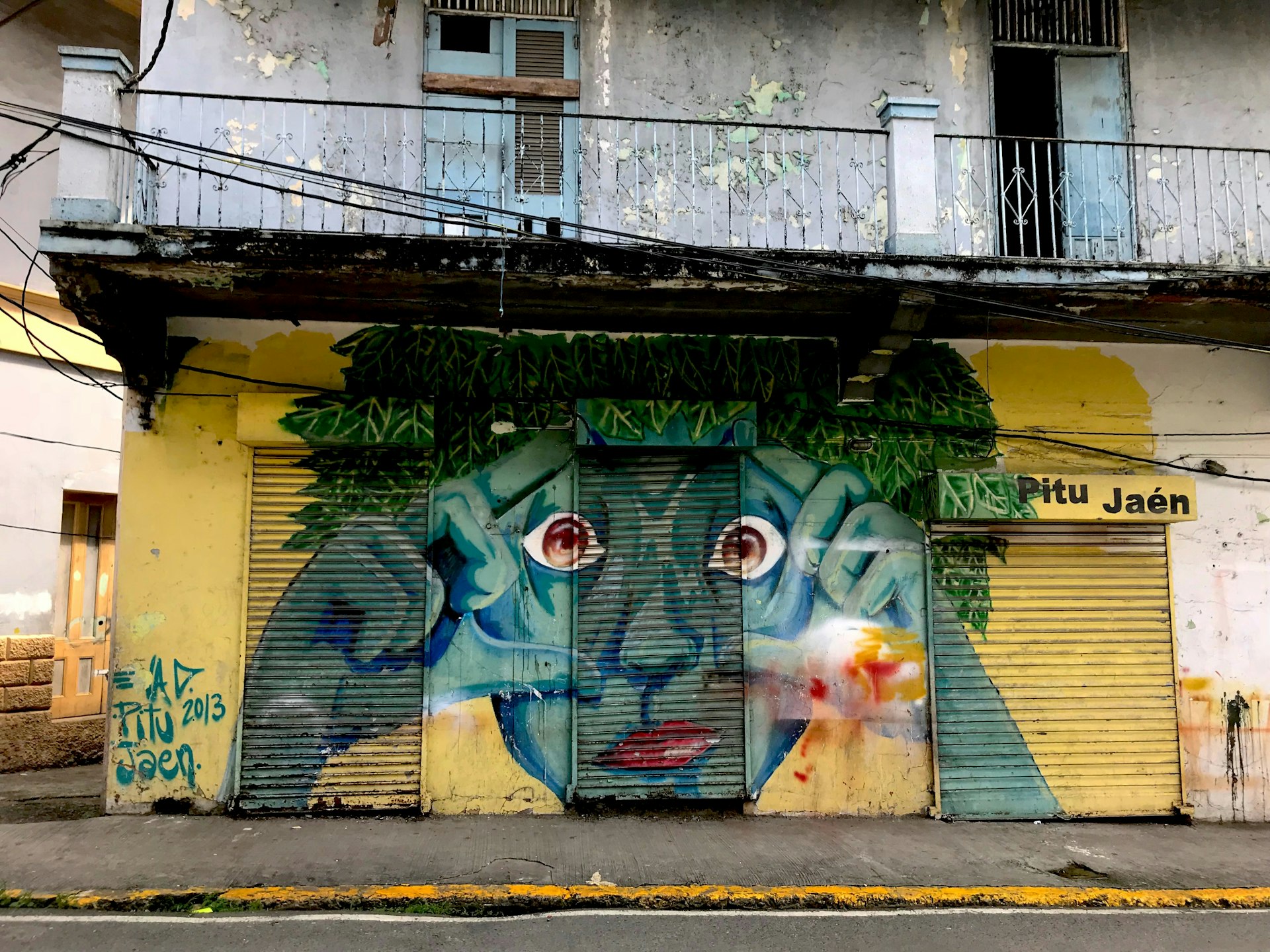 A street art image of a green man opening his eyes in the area of Casco Viejo Martina Gili/Lonely Planet 
