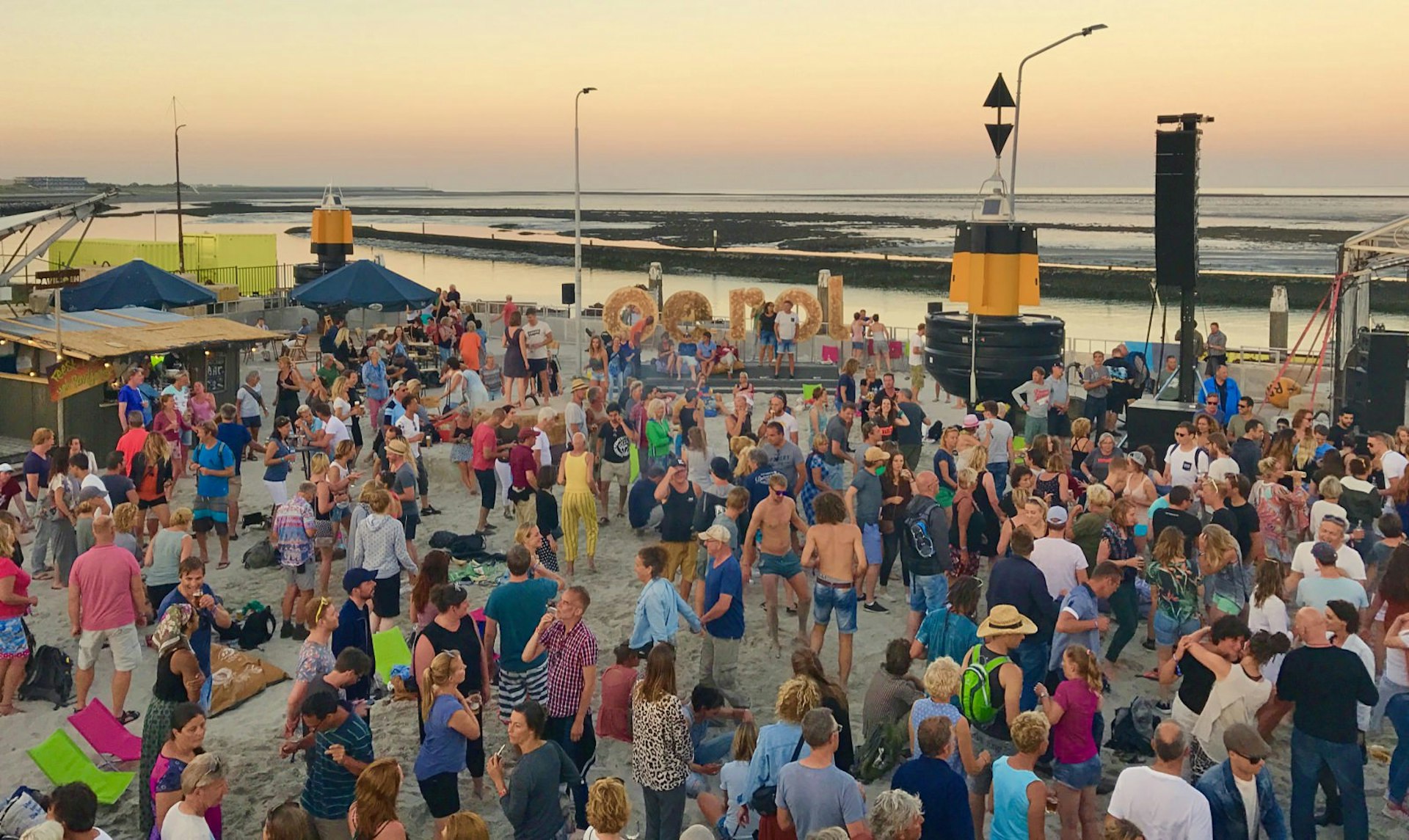 Revellers dance at sunset at the Oerol Festival on the island of Terschelling in The Netherlands
