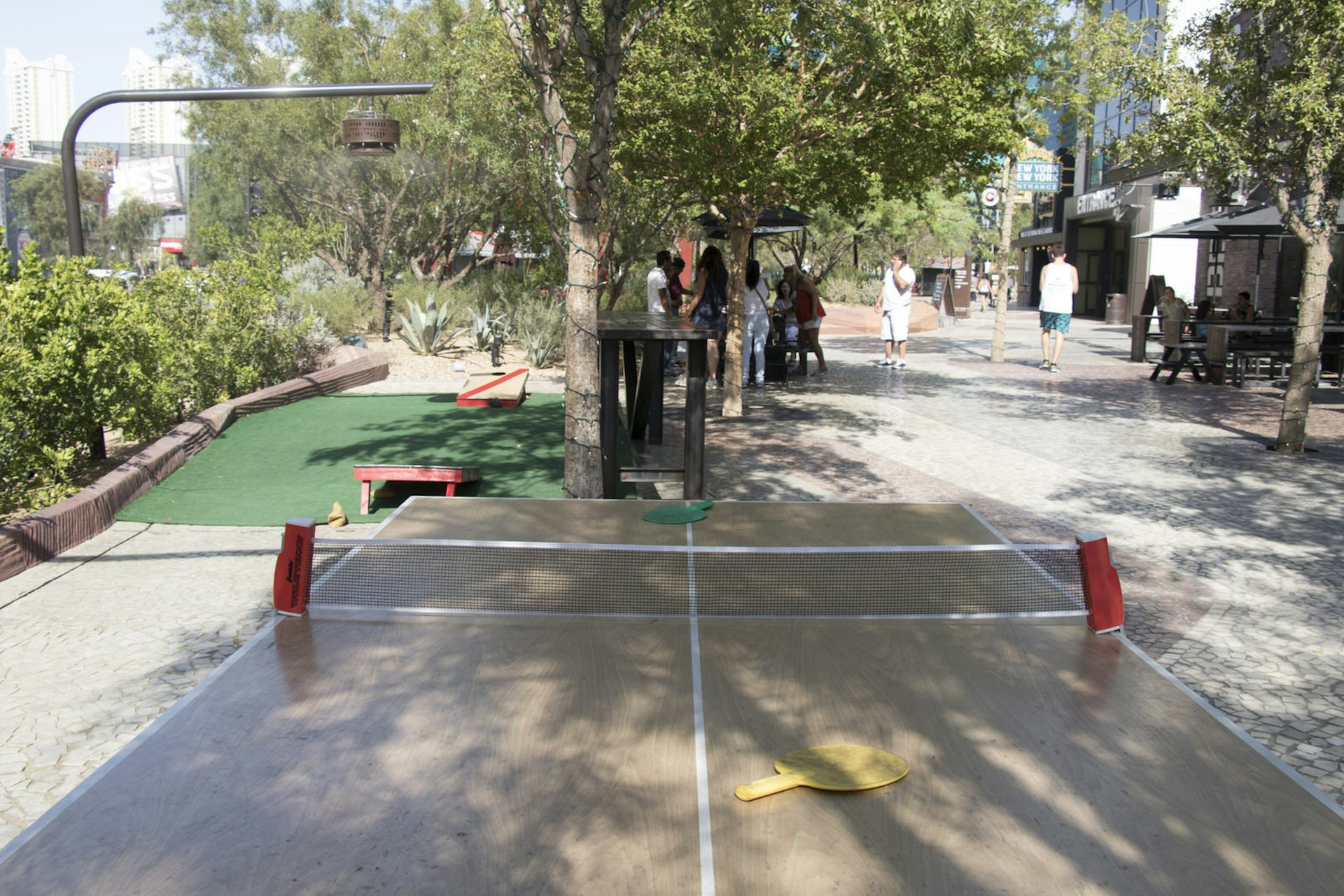 A ping-pong table is set up in an outdoor setting. In the background can be seen a putting green. © Greg Thilmont / Lonely Planet