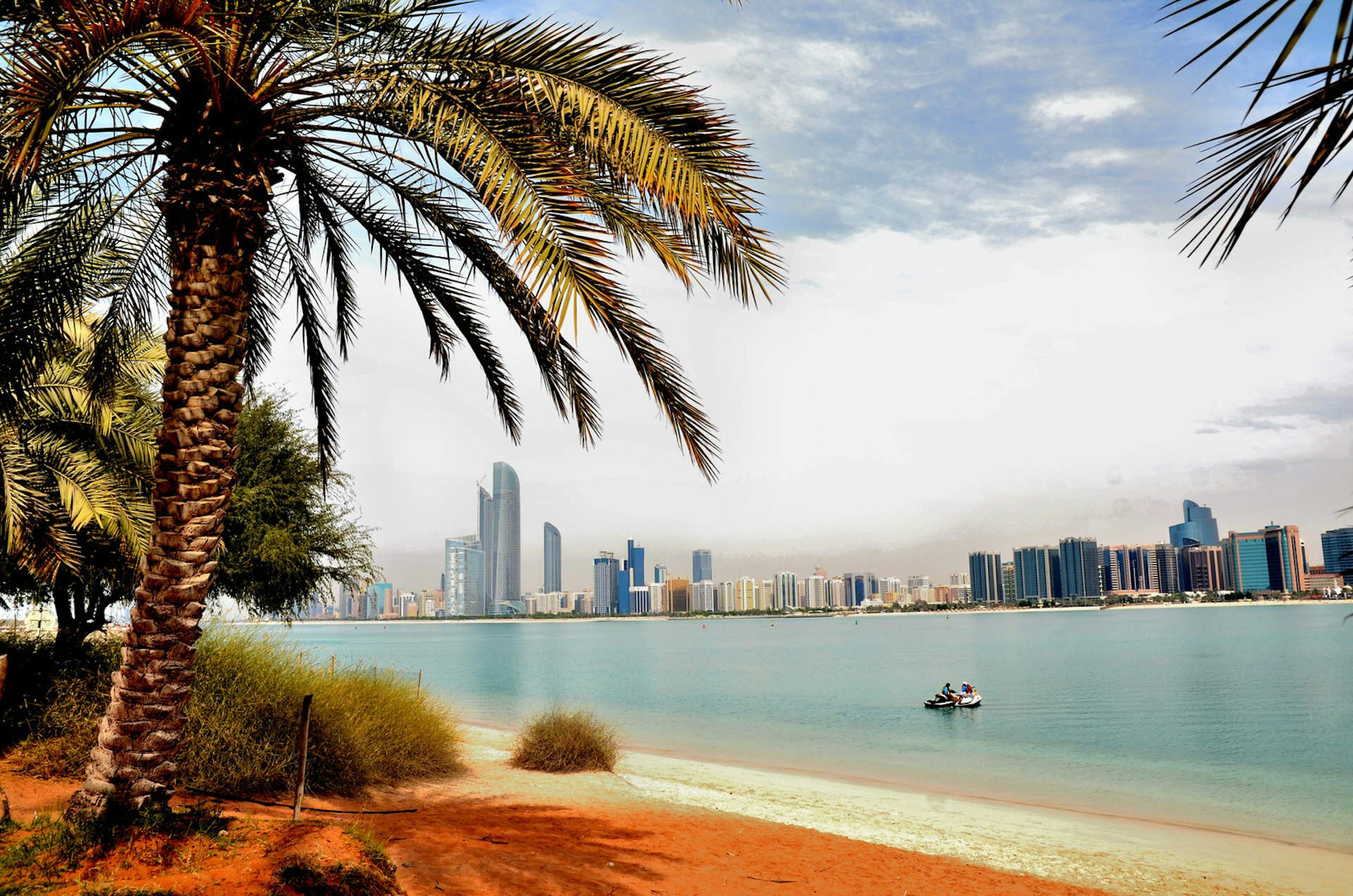 Skyscrapers as seen from a beach in Abu Dhabi, United Arab Emirates. Image by Aleksander Karpenko / Shutterstock