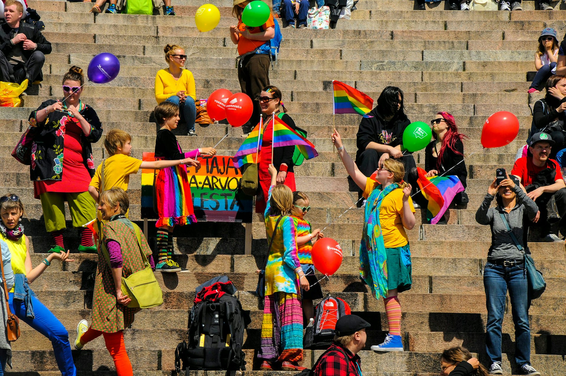 Pride in Europe: Festival-goers hold flags and balloons at Helsinki Pride © Tanja Gavrilovic / Shutterstock