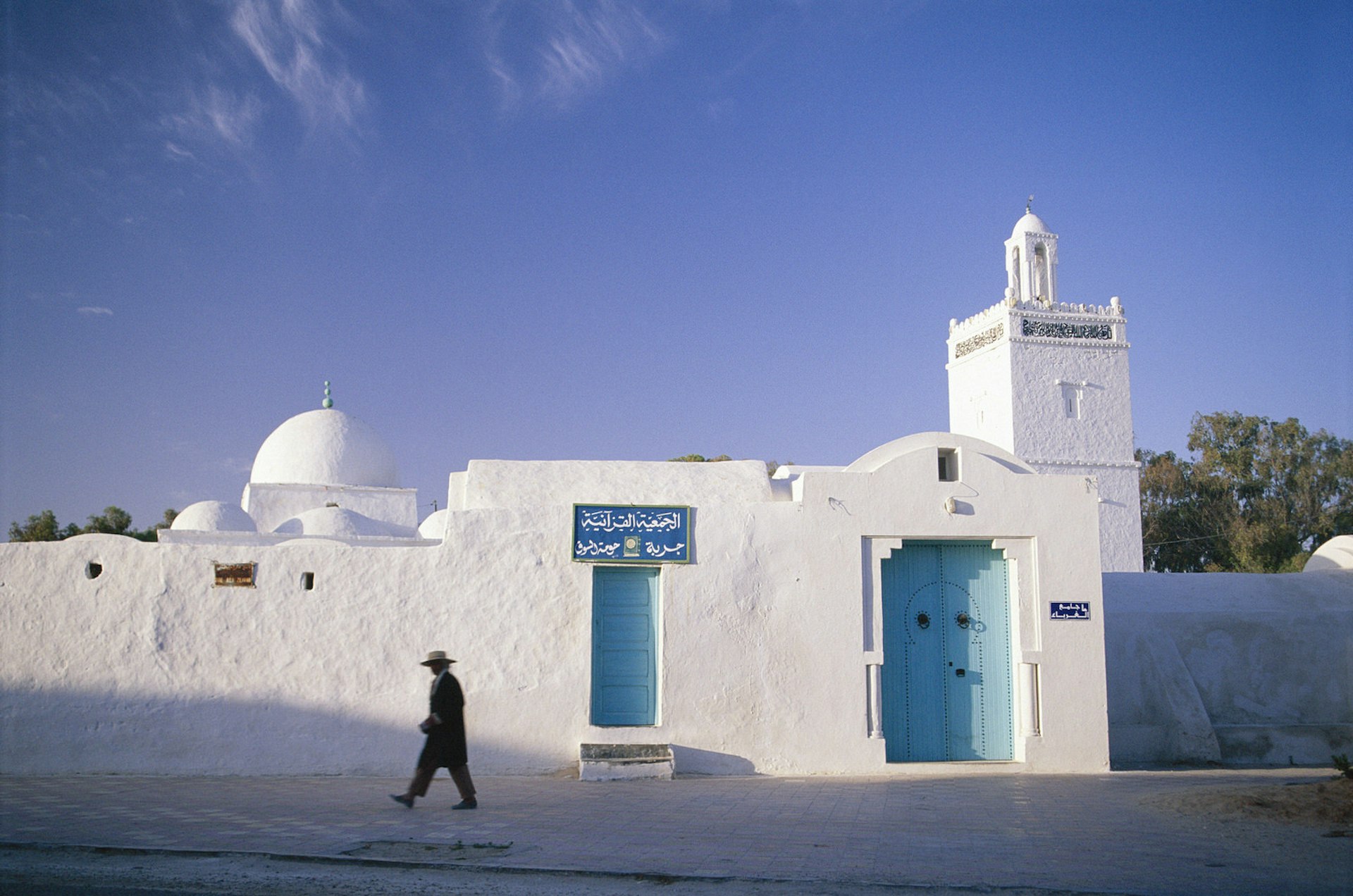 The village of Houmt Souk is a traditional group of one-storey houses with whitewashed walls, and a small mosque with tower. Image by Travel Ink / Getty Images