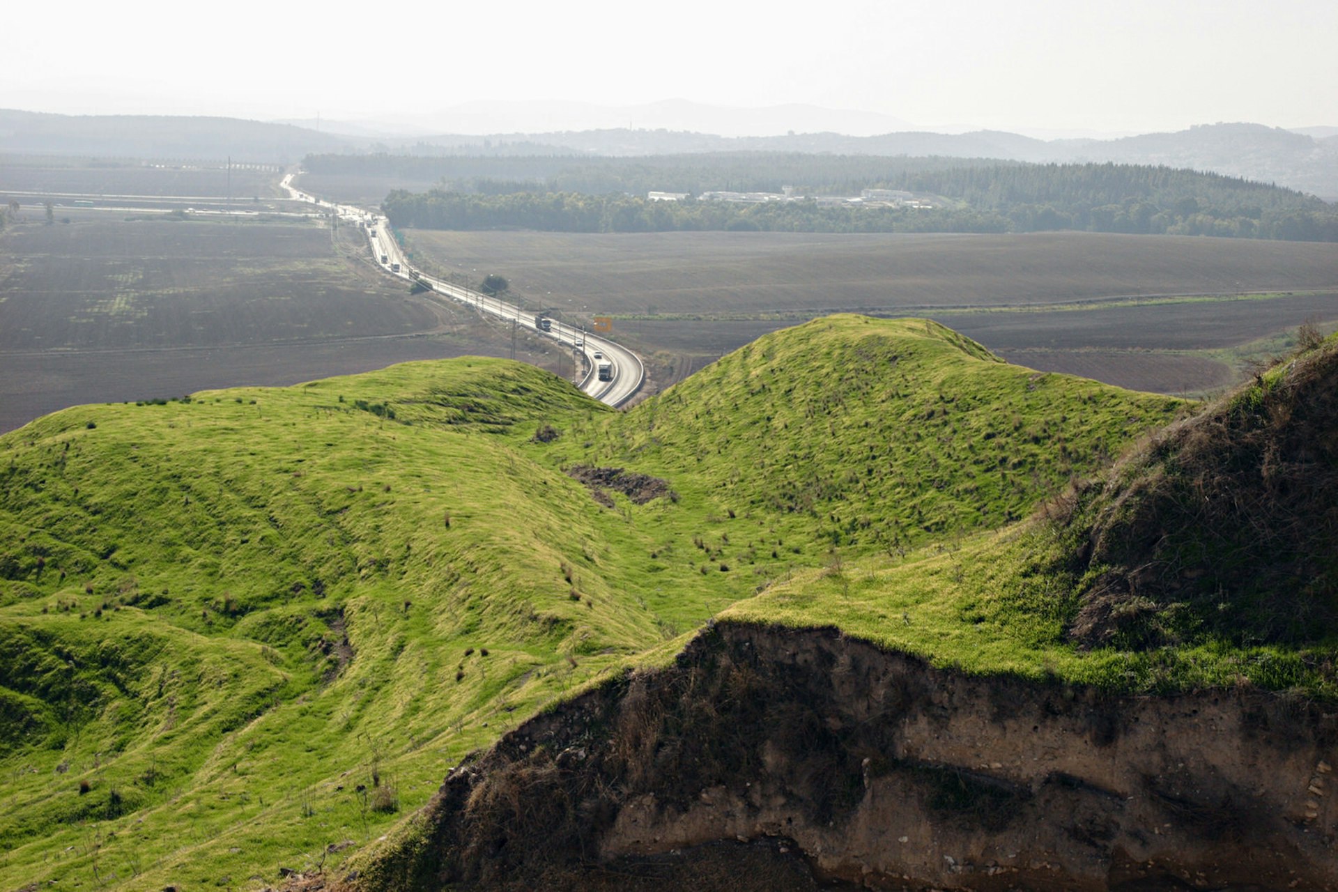 Tel Megiddo (Armageddon) overlooking the Valley of Jezreel, Israel. In the foreground is where the archaeologists were digging. Image by Dan Porges / Getty Images
