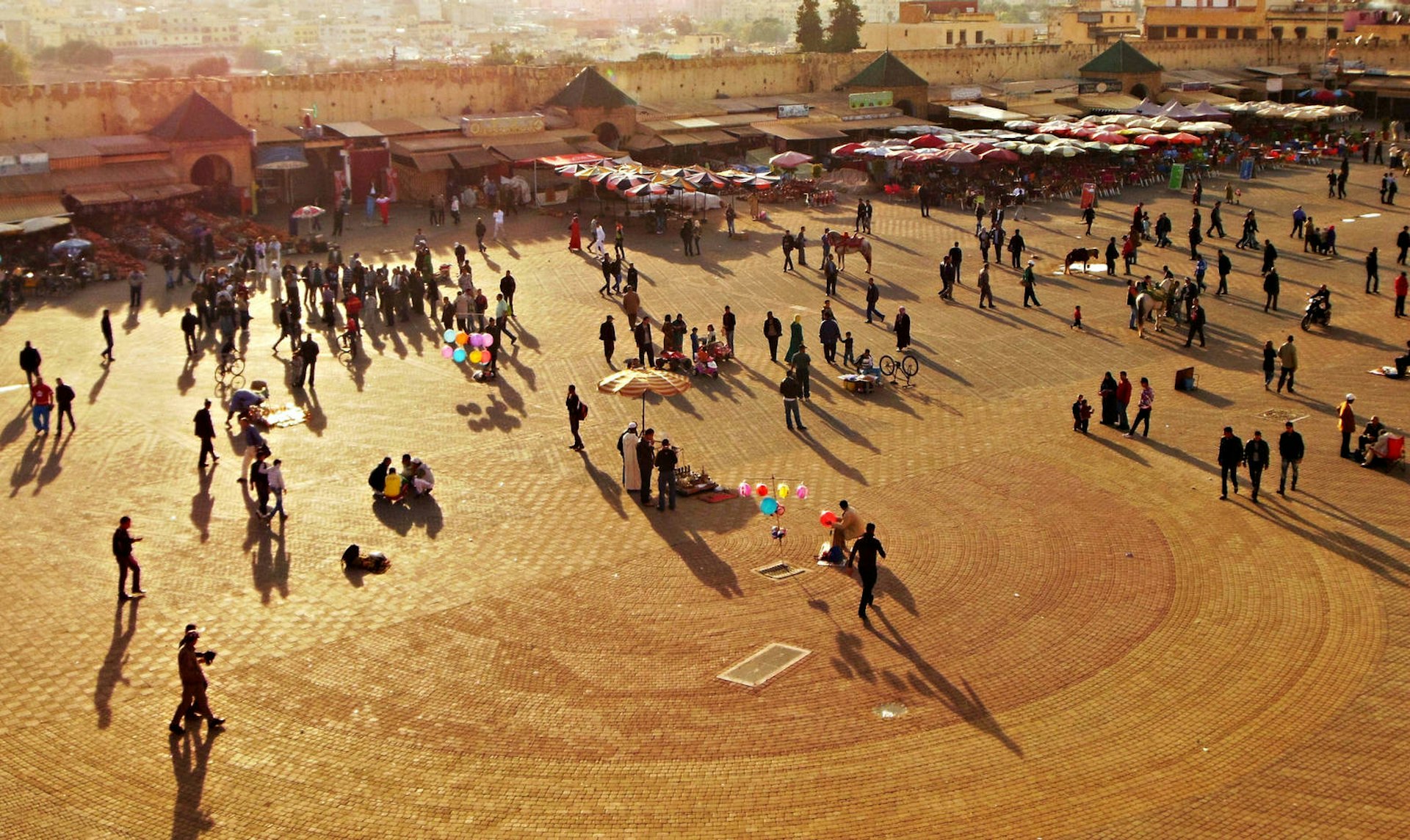 Sunset on Place El Hedim, Meknes, Morocco. Image by Rolf Bach / Getty Images