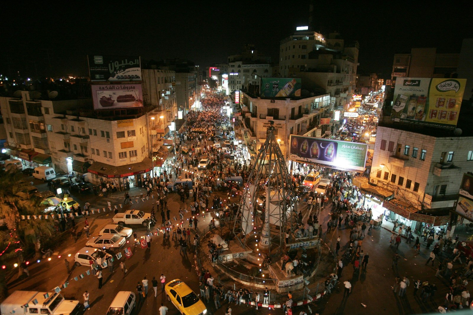 Night scene in the West Bank city of Ramallah, Palestinians in the streets at evening on the last day of the holy month of Ramadan.. Image by Abbas Momani / Getty Images