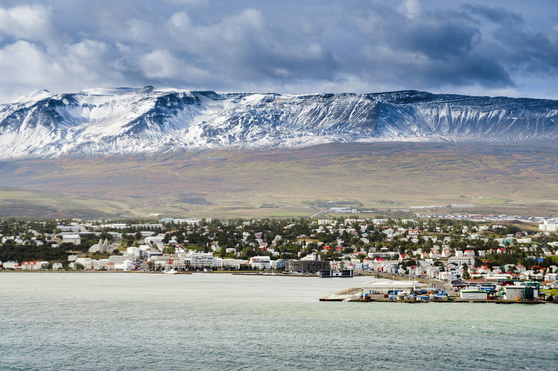 Flat-topped and snow-capped mountains back the city of Akureyri and its harbour on Eyjafjordur. This city marks the start of the North Iceland road trip ©subtik / Getty Images