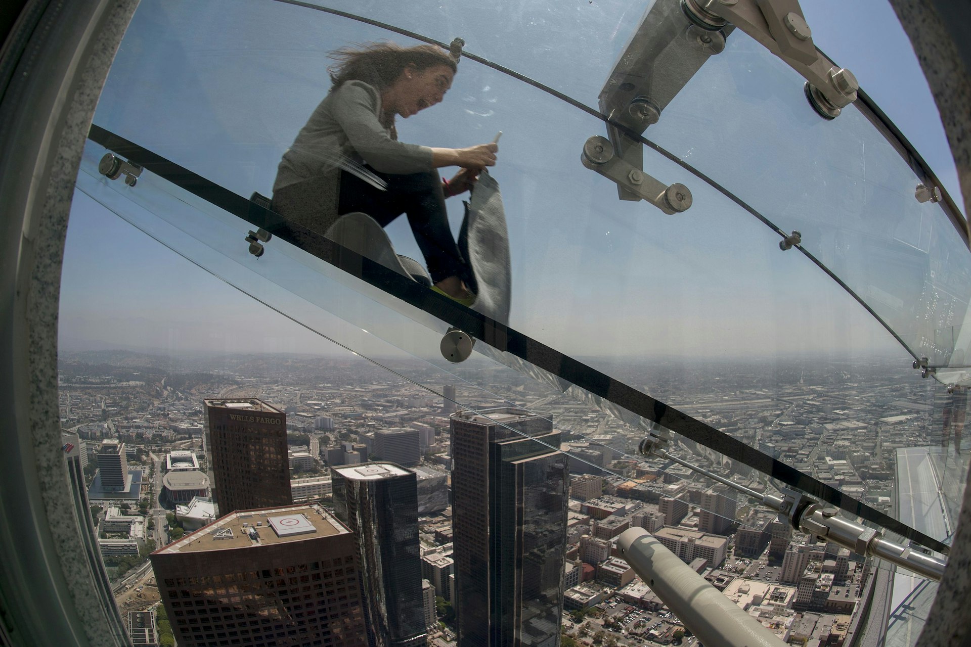 Woman slides down the Skyslide, a 45-foot outdoor glass slide 70 floors up on the outside of the US Bank Tower Woman slides down the Skyslide, a 45-foot outdoor glass slide 70 floors up on the outside of the US Bank Tower © David Mcnew / Getty Images