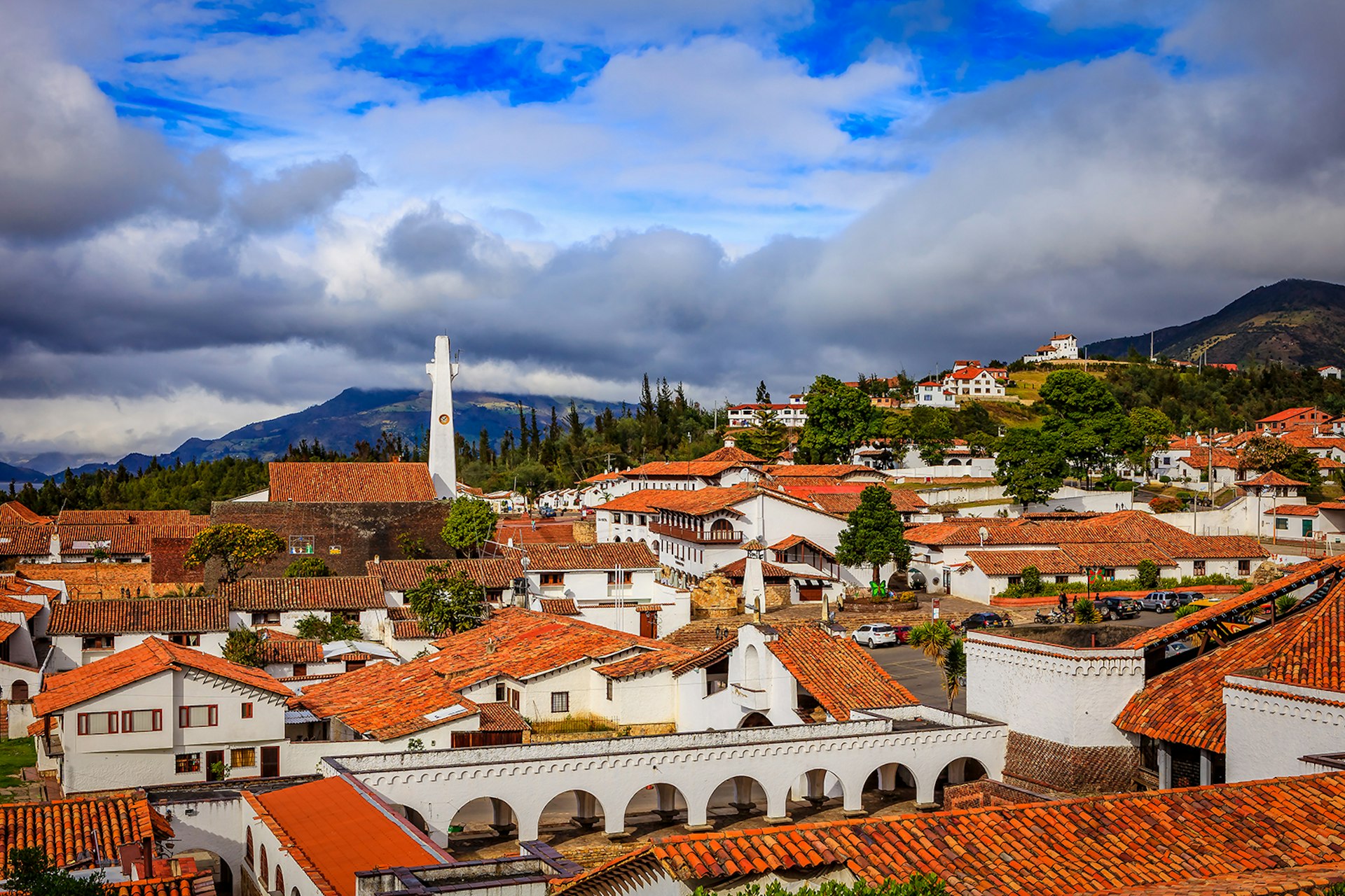 A collection of white buildings with terracotta roofs in Guatavita, Colombia