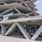 One Airport Square, a new building in Accra that looks like an uneven stack of cards, with each card supported (and separated from the next) by a jumble of massive concrete tootpicks © Elio Stamm / Lonely Planet