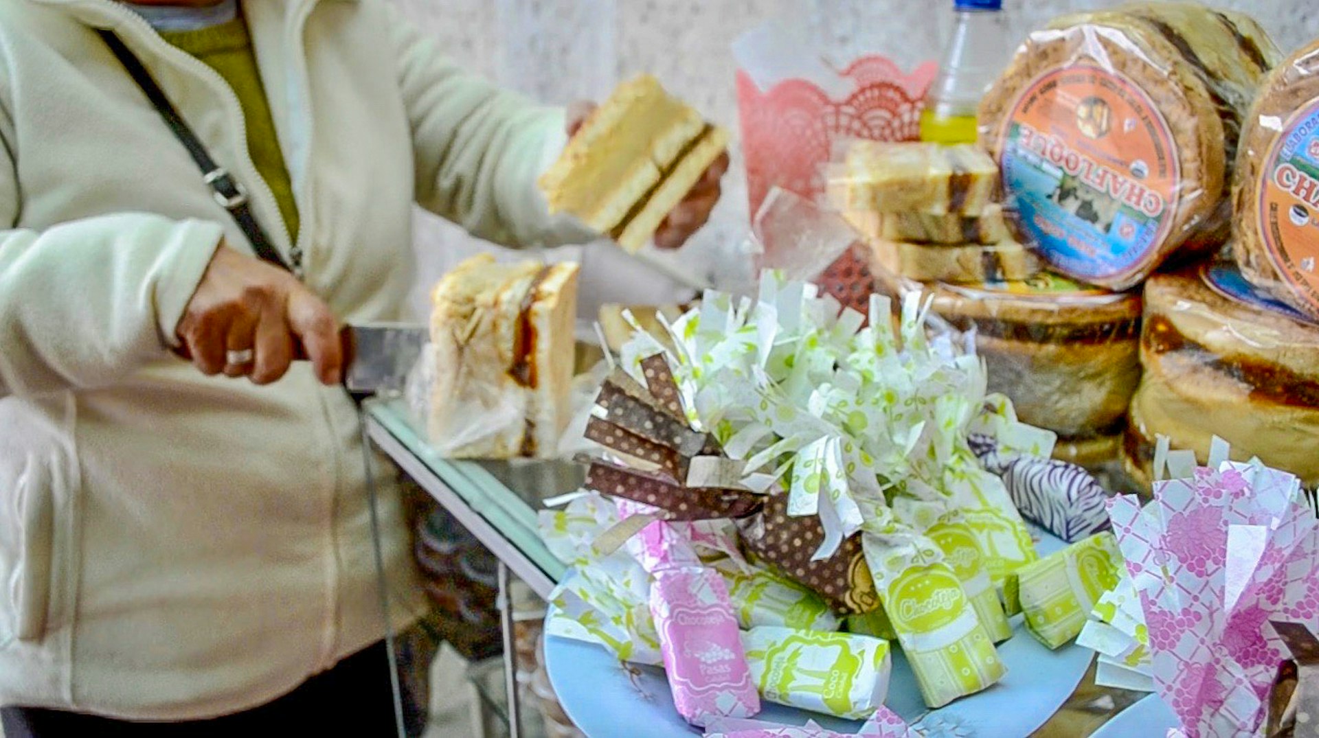A woman cuts a dessert inPeru