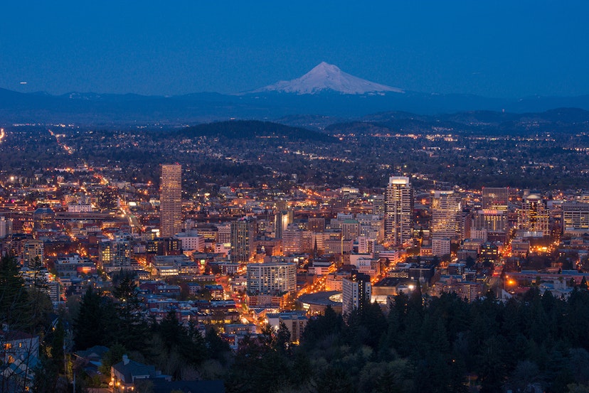Downtown Portland at dusk from Pittock Mansion, with Mount Hood in the background © Piriya Photography / Getty Images