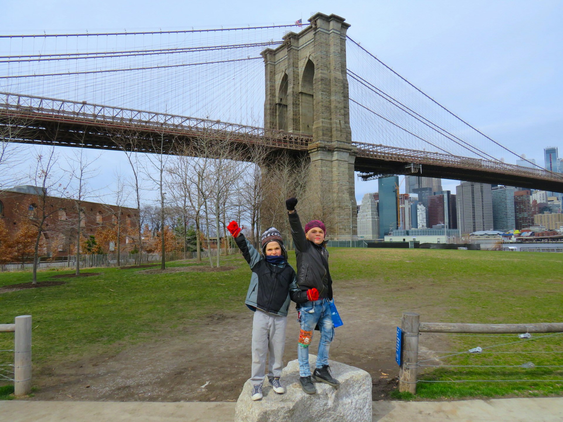Rohan and Kai showcase their superhero moves in front of the Brooklyn Bridge © Ethan Gelber / Lonely Planet