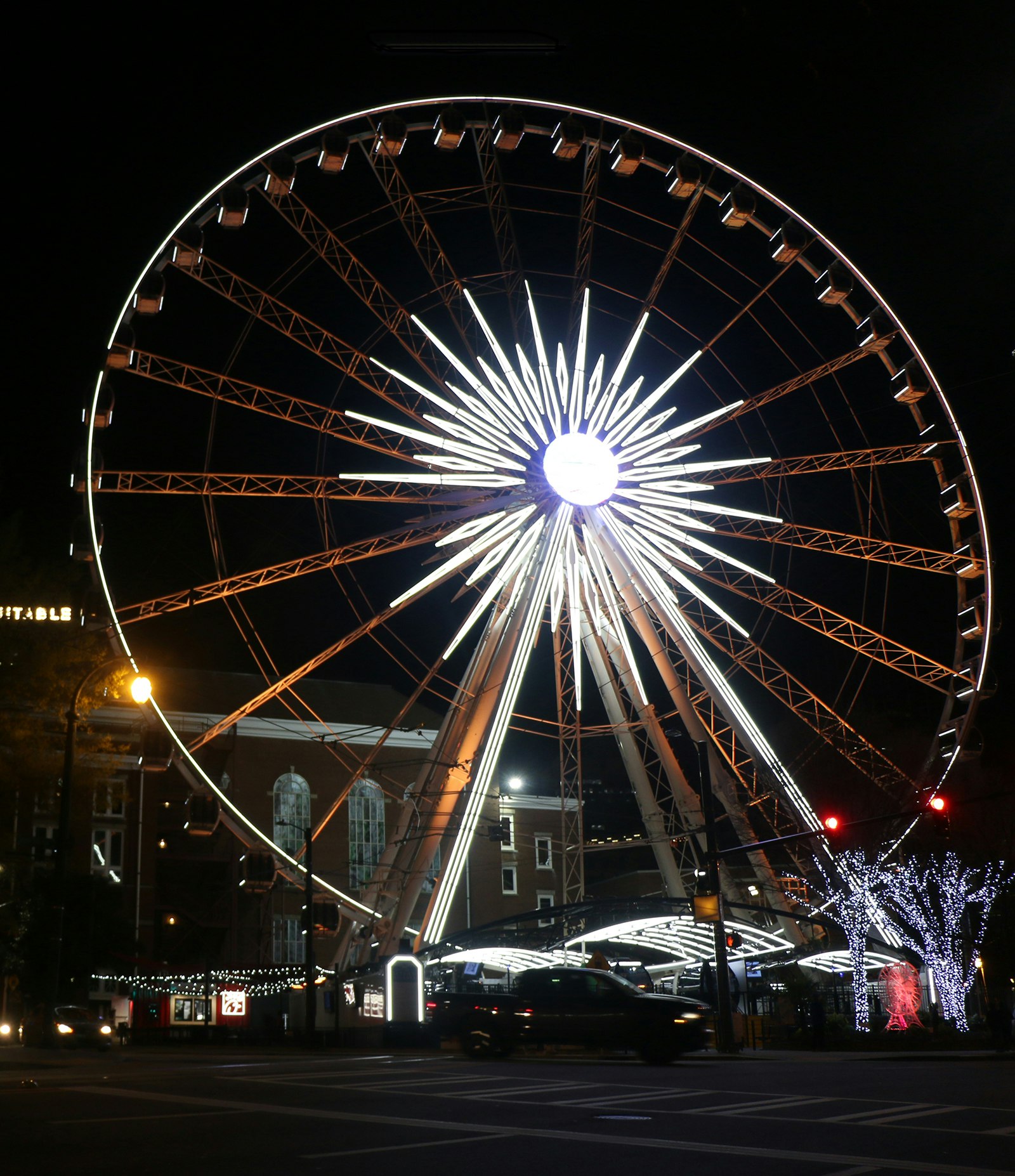 Large Ferris wheel in the center of Atlanta is lit up at night © Ni'Kesia Pannell / Lonely Planet