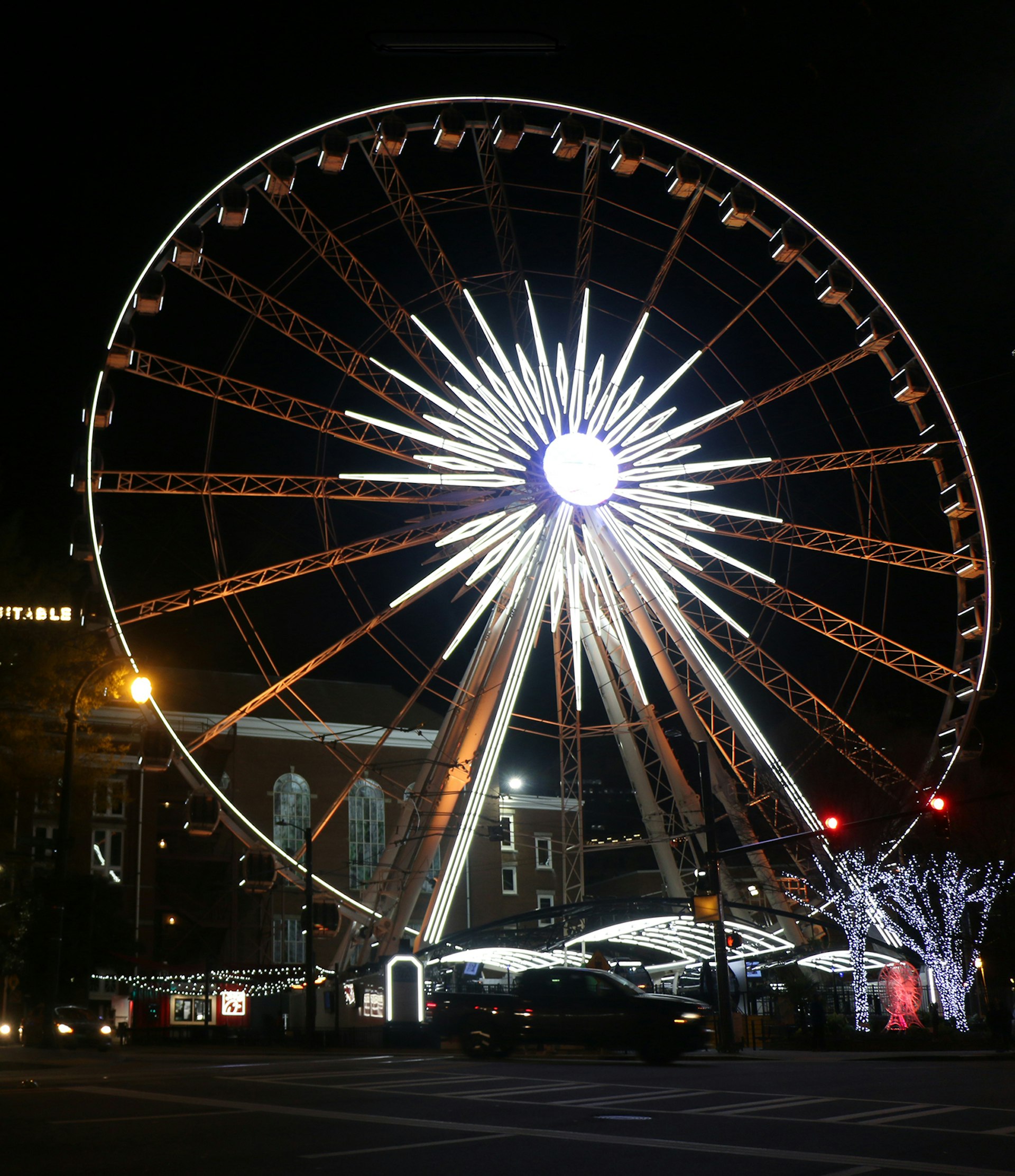 Large Ferris wheel in the center of Atlanta is lit up at night © Ni'Kesia Pannell / Lonely Planet
