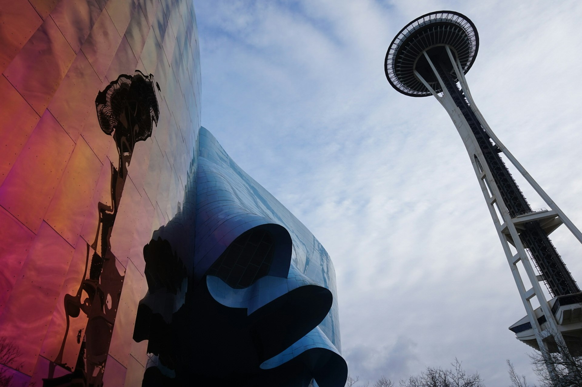 The landmark Space Needle tower in Seattle is seen on the right, and reflected in a red mirrored wall on the left © Brendan Sainsbury / Lonely Planet 