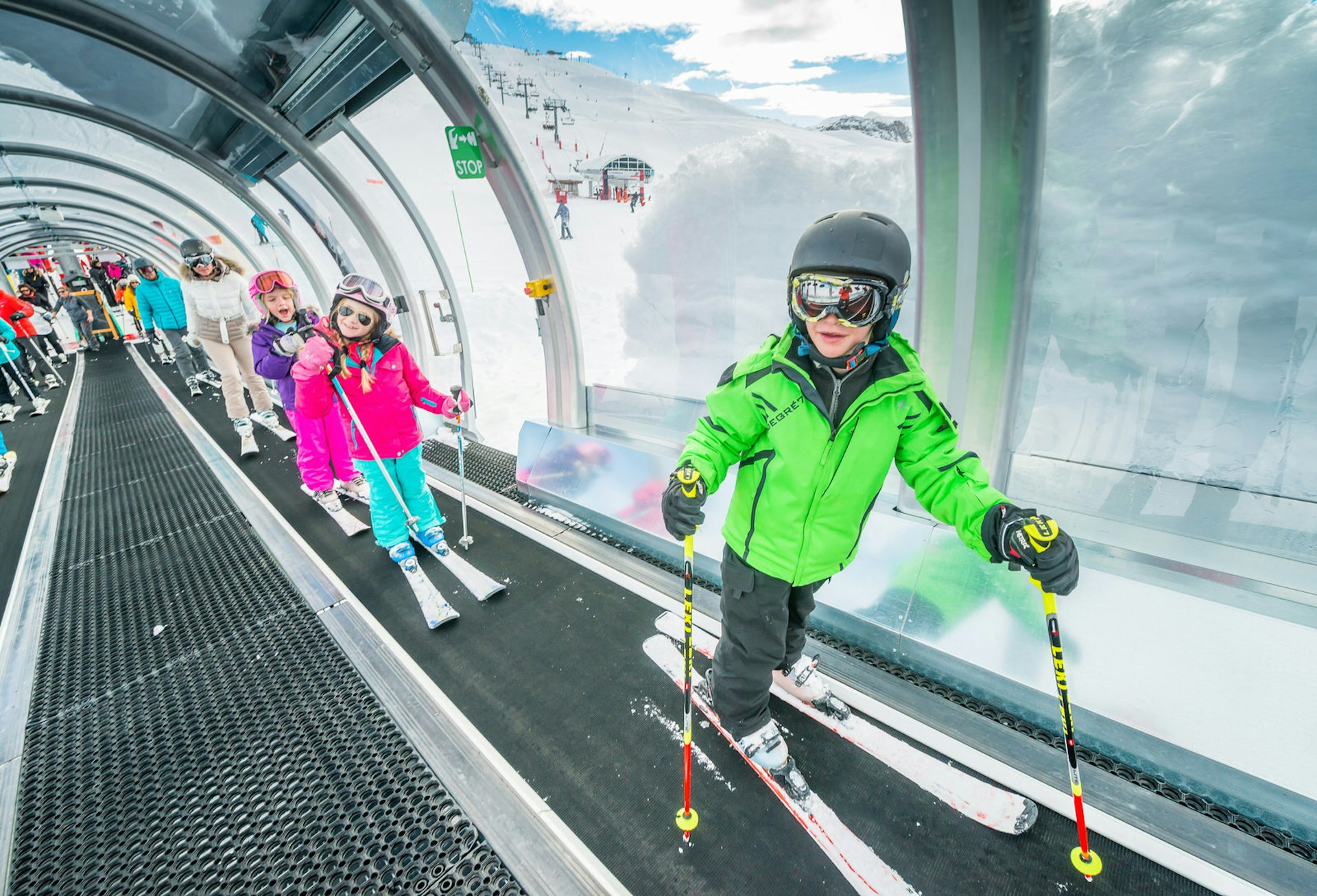 Children ride up one of the magic carpet lifts in Solaise © Val d'Isère