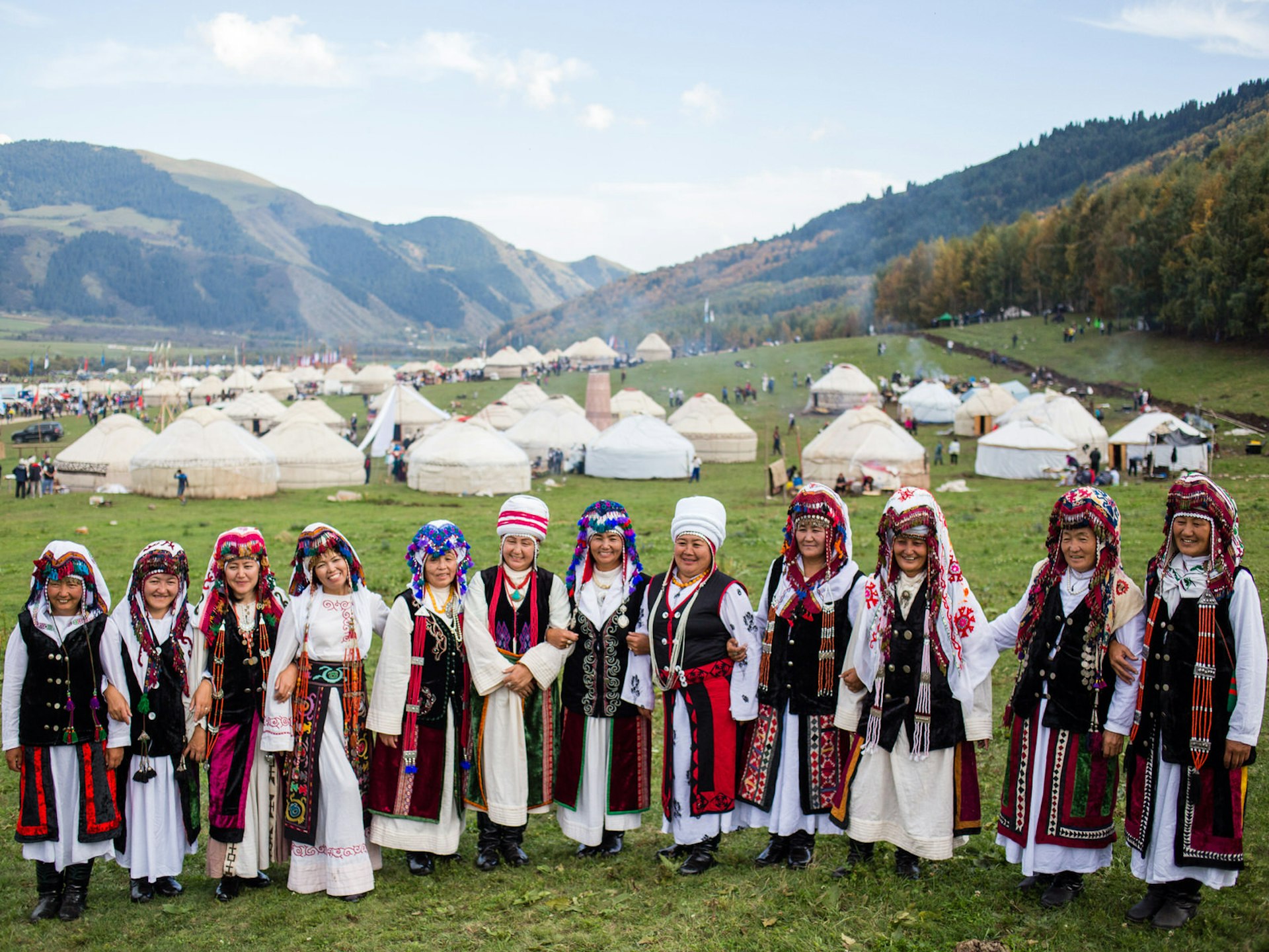 Southern Kyrgyzstan women in traditional dress at the World Nomad Games yurt camp at Kyrchyn Jailoo © Stephen Lioy / Lonely Planet